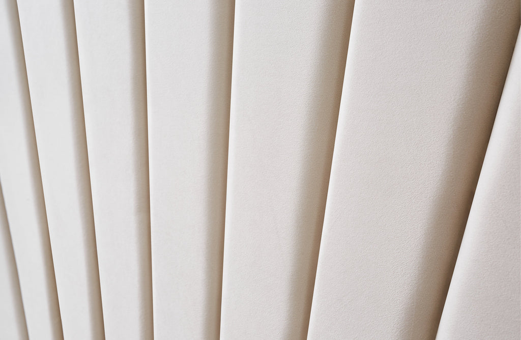 Detailed view of Allure Velvet Bed Beige headboard with vertical tufting and soft velvet texture.