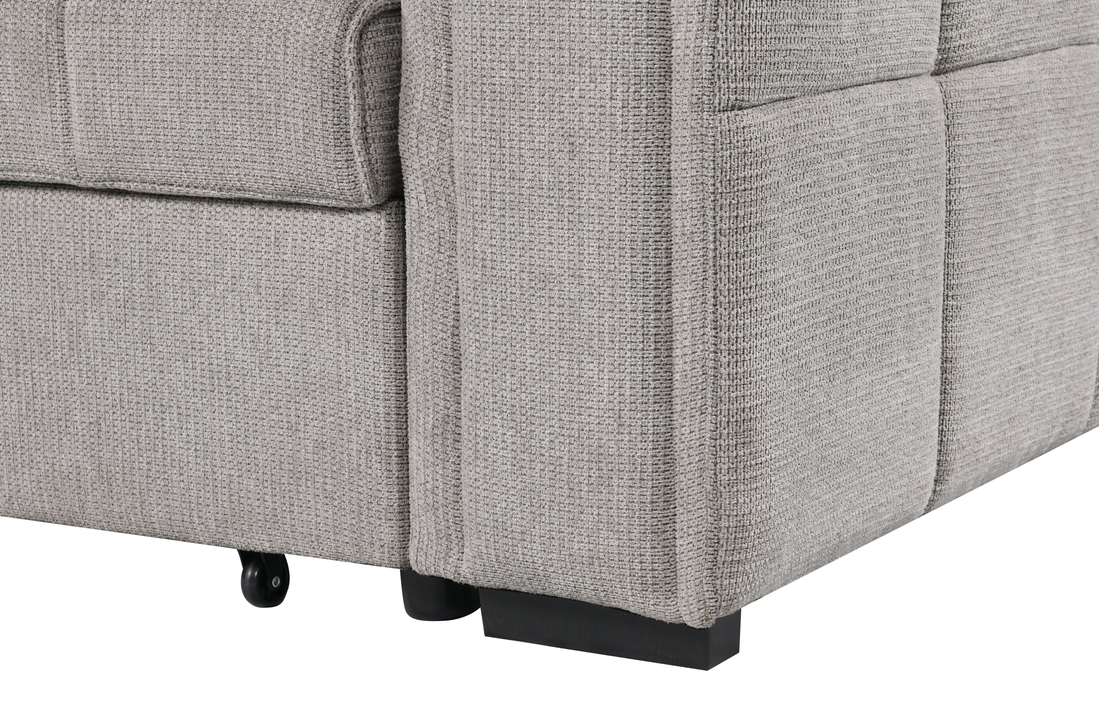 Close-up view of beige fabric sofa armrest and base, highlighting the textured upholstery, clean stitching, and sturdy black legs with rolling support wheel.