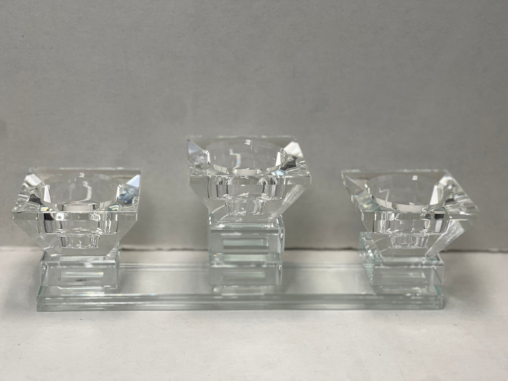 Three-cup crystal tea light holder on a glass base, displayed against a neutral background.