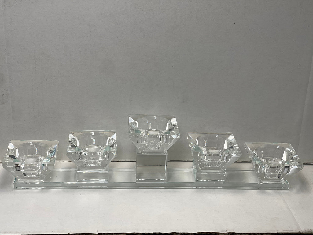 Crystal-clear tea light candle holder with five diamond-shaped cups on a long rectangular base