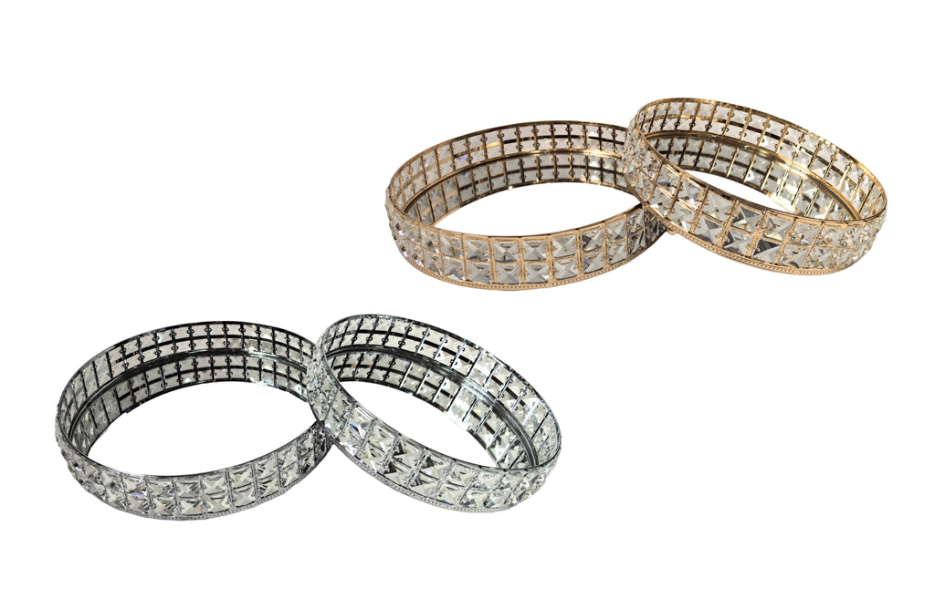 Katie round tray sets in both gold and silver finishes, each with crystal accents and mirrored bases, available in two sizes.