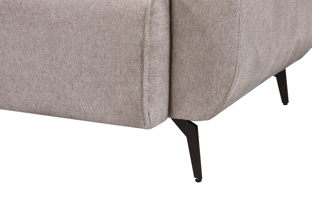 Detailed side view of the Maddox Lounge Sofa leg featuring a matte black metal finish and textured beige fabric upholstery, showcasing its clean seam and modern tapered support.