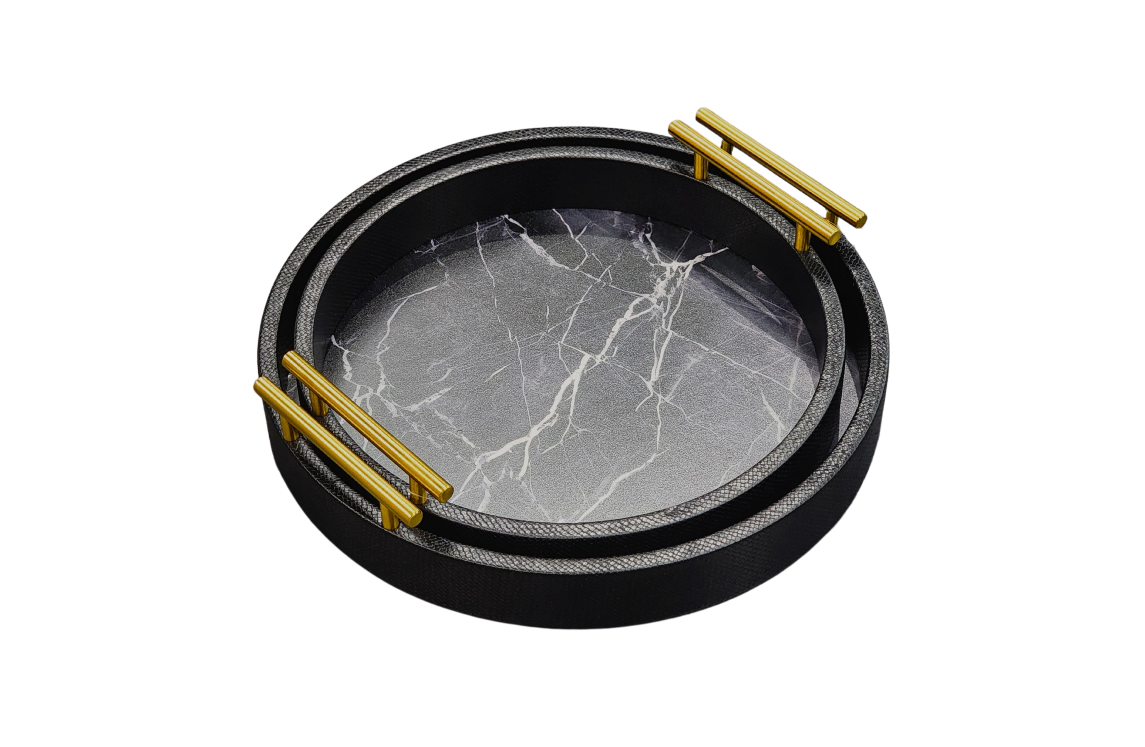 Stacked black round marble trays with gold handles, featuring faux marble base in medium and small sizes.