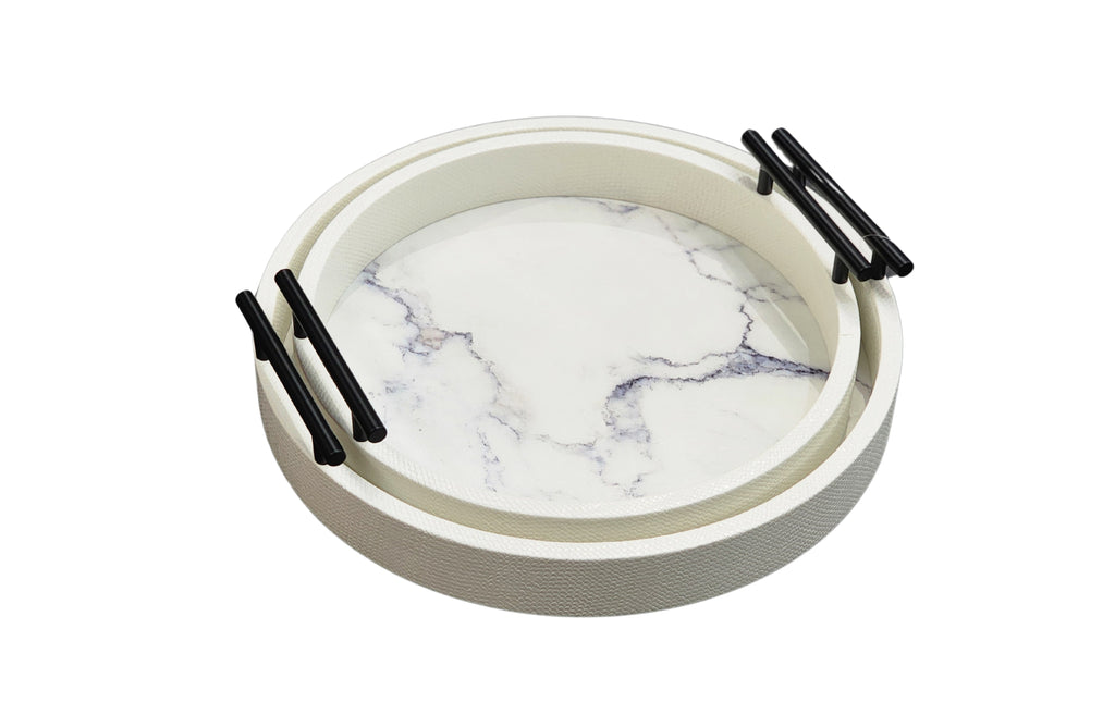 Stacked white round marble trays with gold handles, featuring faux marble base in medium and small sizes.