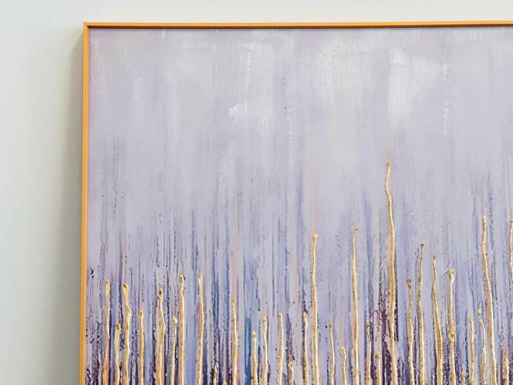 Close-up of gold-framed canvas showing textured gold streaks over a blue and lavender gradient background.