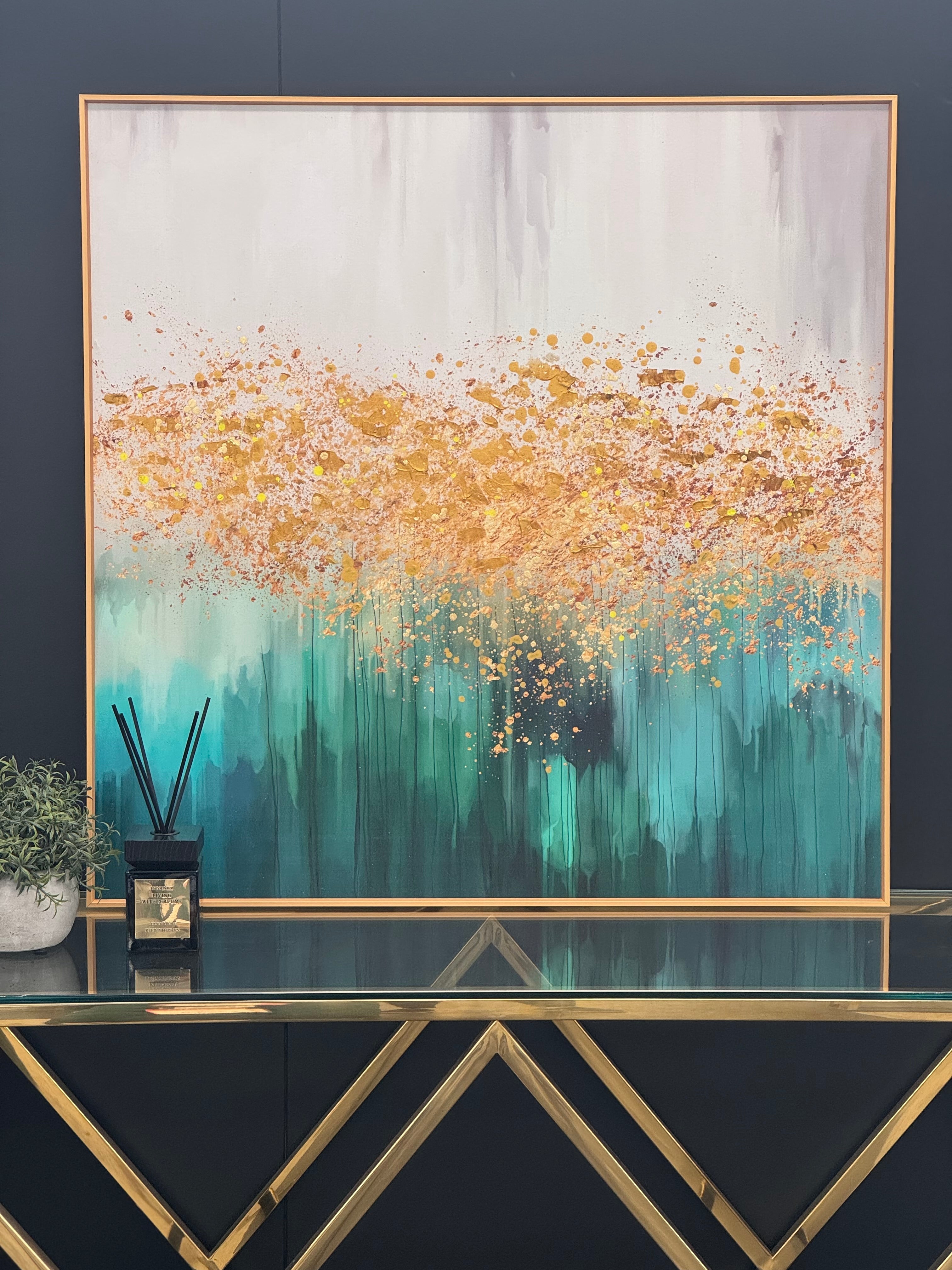 Pacific Green Square Wall Art displayed above a gold console table – abstract green and gold painting framed in metallic gold for luxury interiors