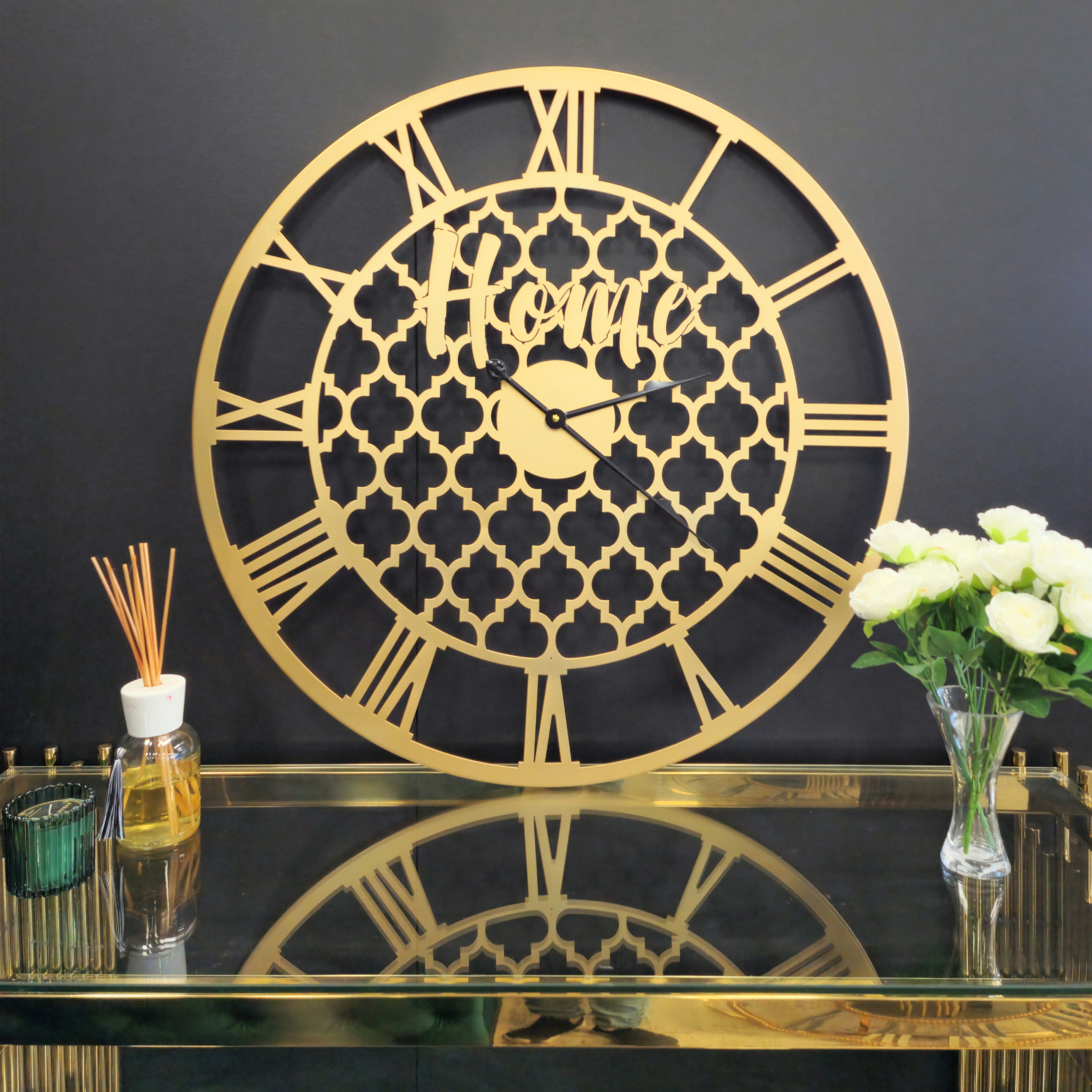 Gold quatrefoil wall clock displayed on interior wall, adding luxury and timeless sophistication.
