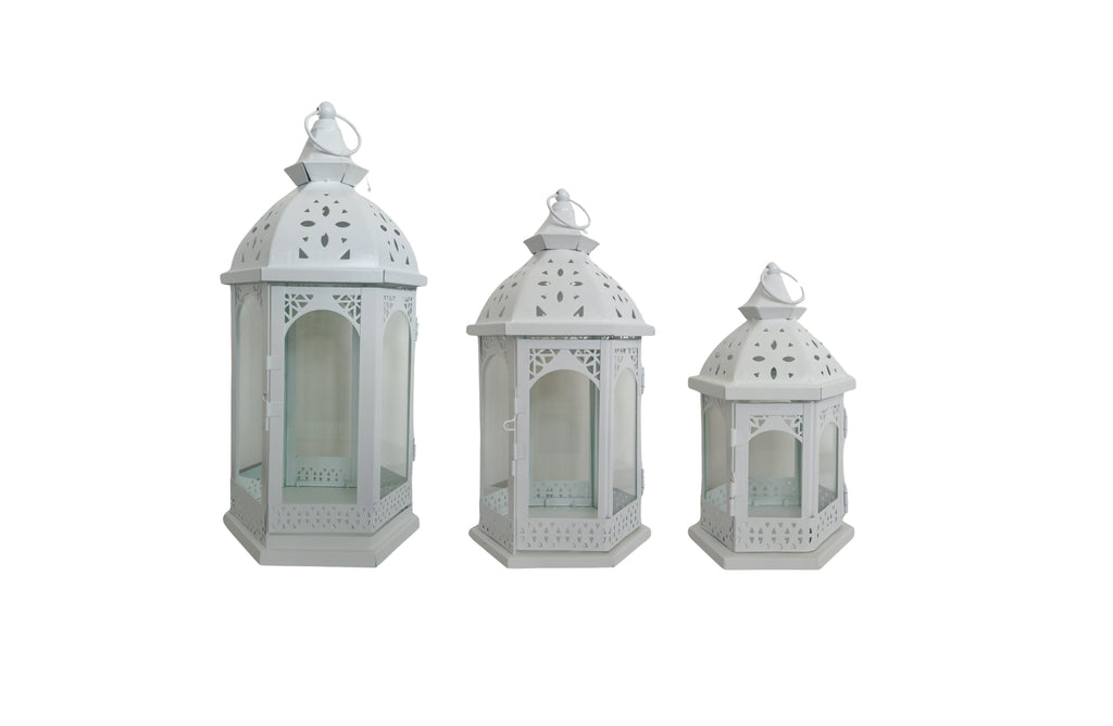 White Metal Lantern Set of 3 – intricately designed lanterns in small, medium, and large sizes with glass panels and arched cut-outs