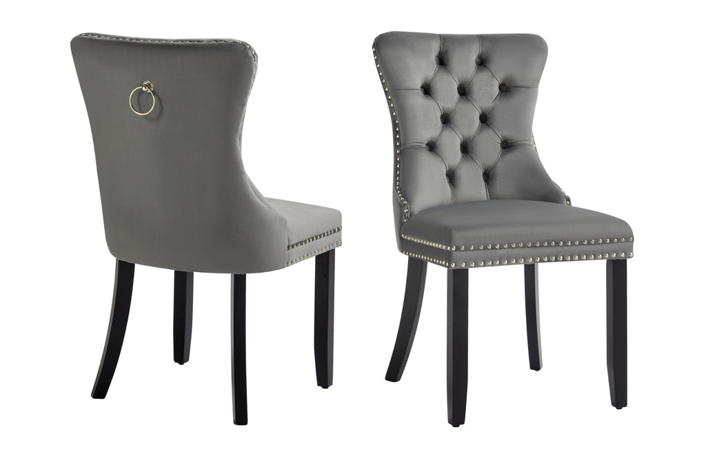 Pair of Alsea dark grey velvet dining chairs with tufted back and black rubberwood legs.