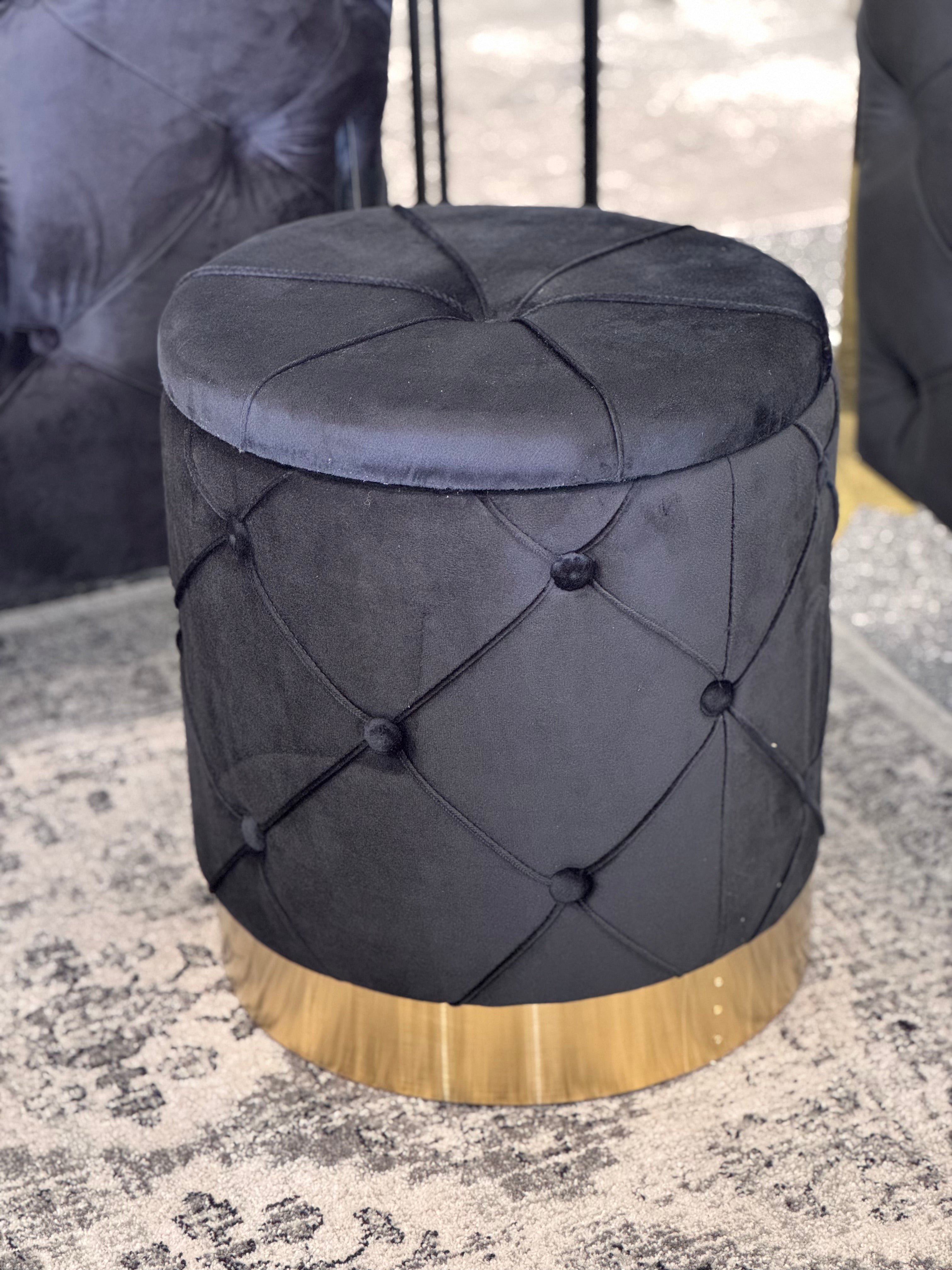 Black Amy Storage Ottoman with gold base styled in room setting with modern décor