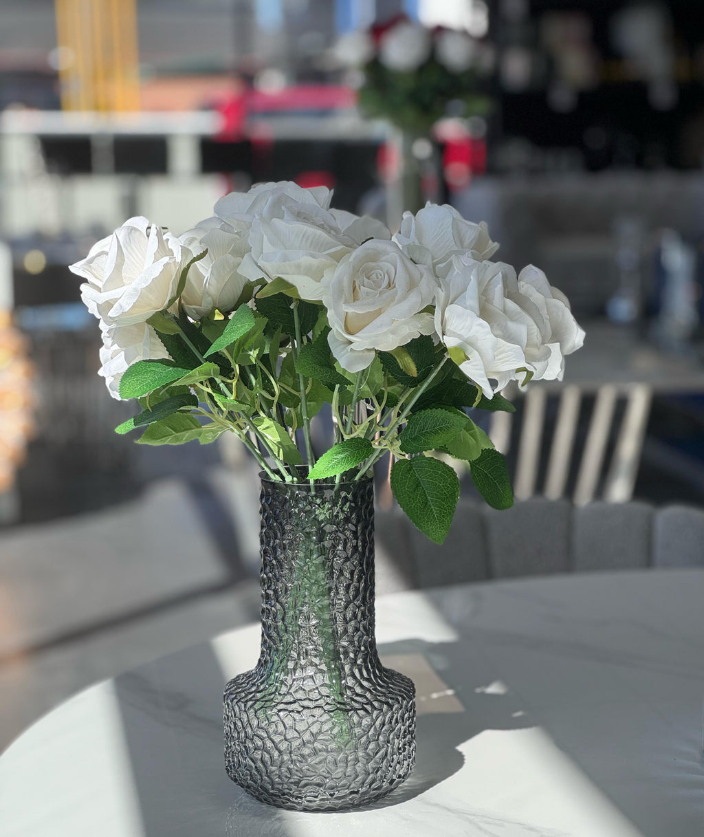 White artificial roses in vase, styled for chic table décor.