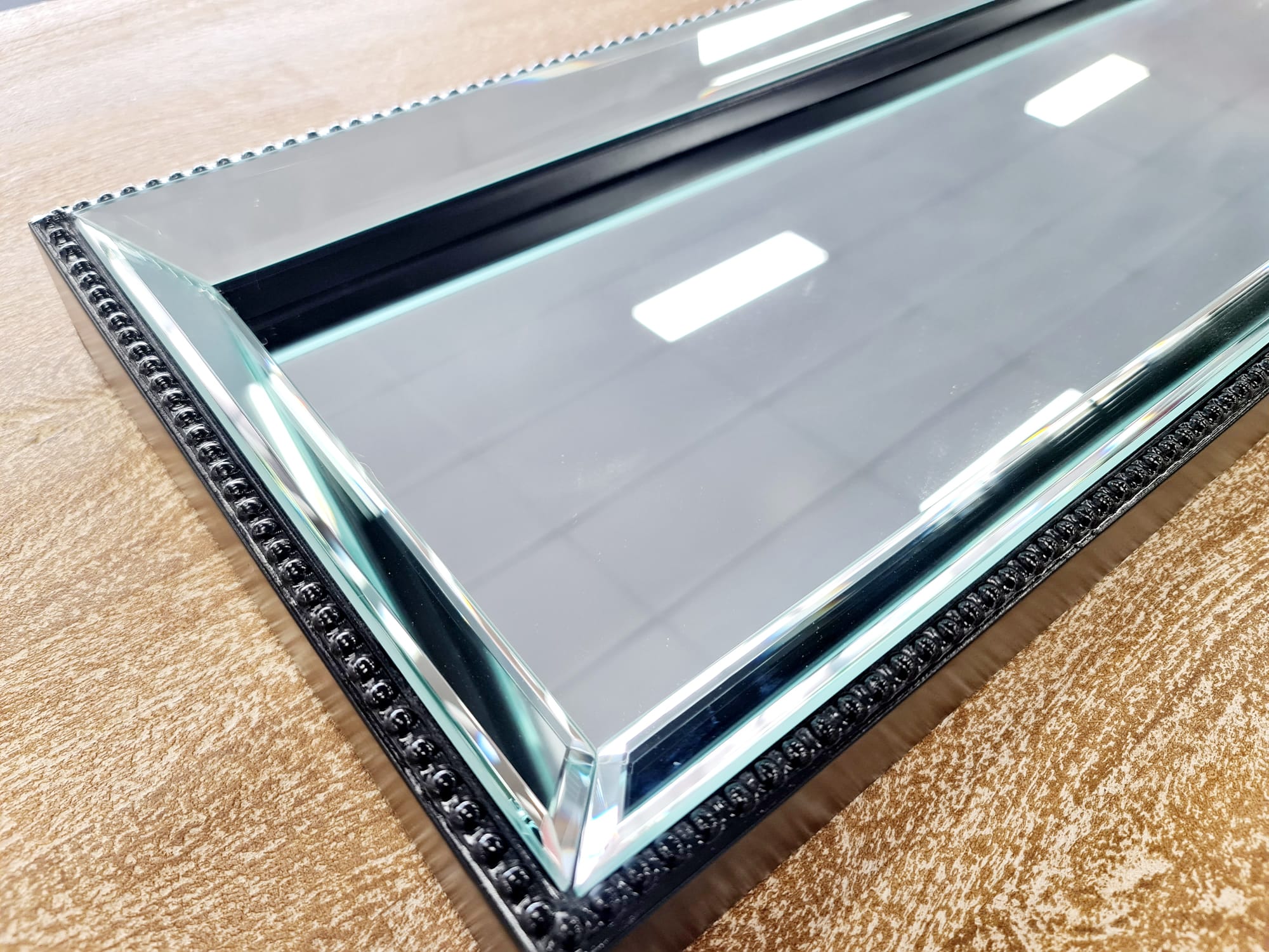 Close-up of black beaded mirror tray – luxe detail and shine.
