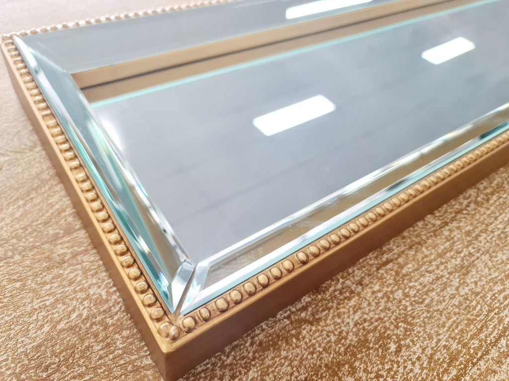 Close-up of gold beaded mirror tray – elegant and radiant finish.