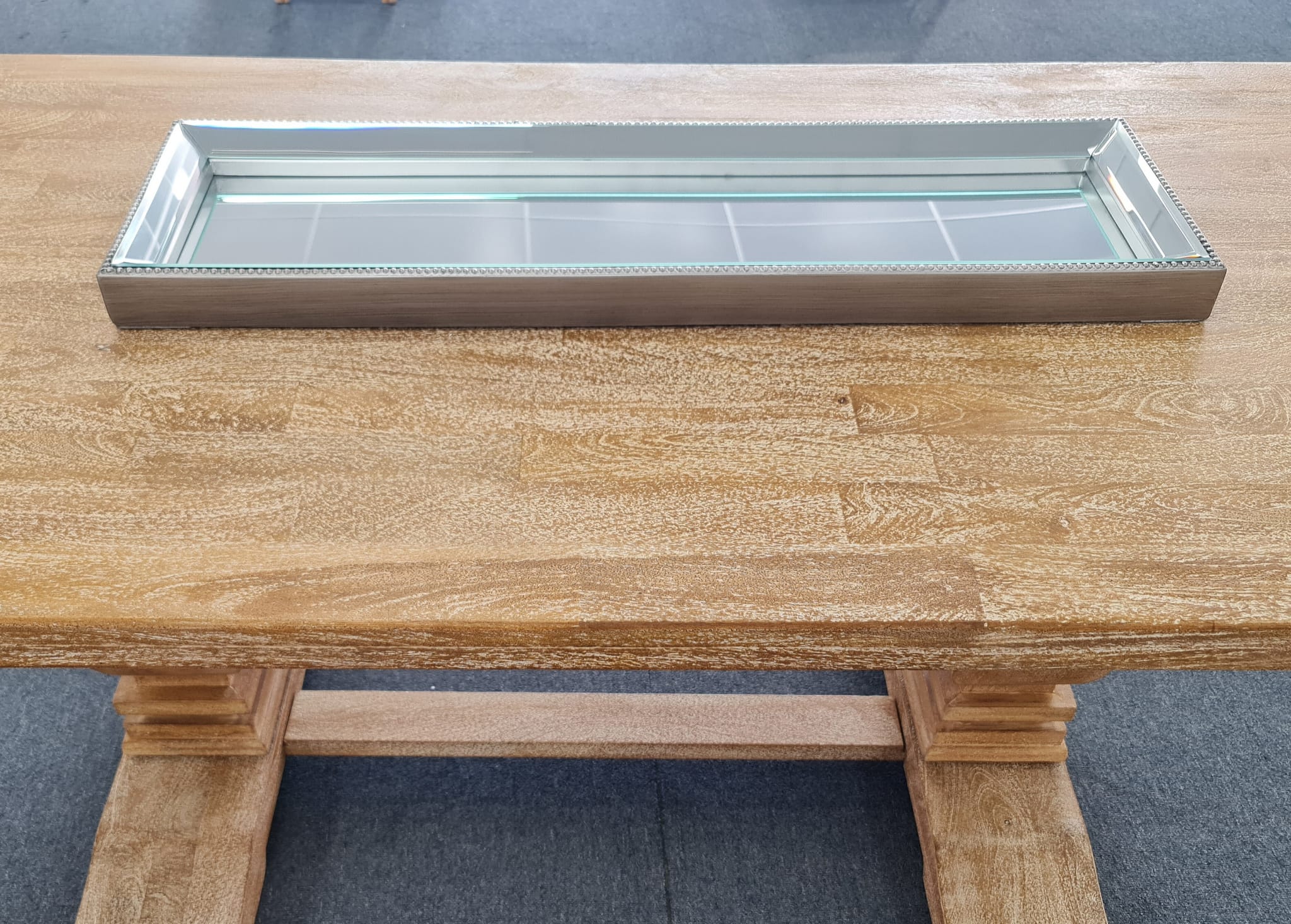 Elegant silver mirror tray with a luxe beaded frame.