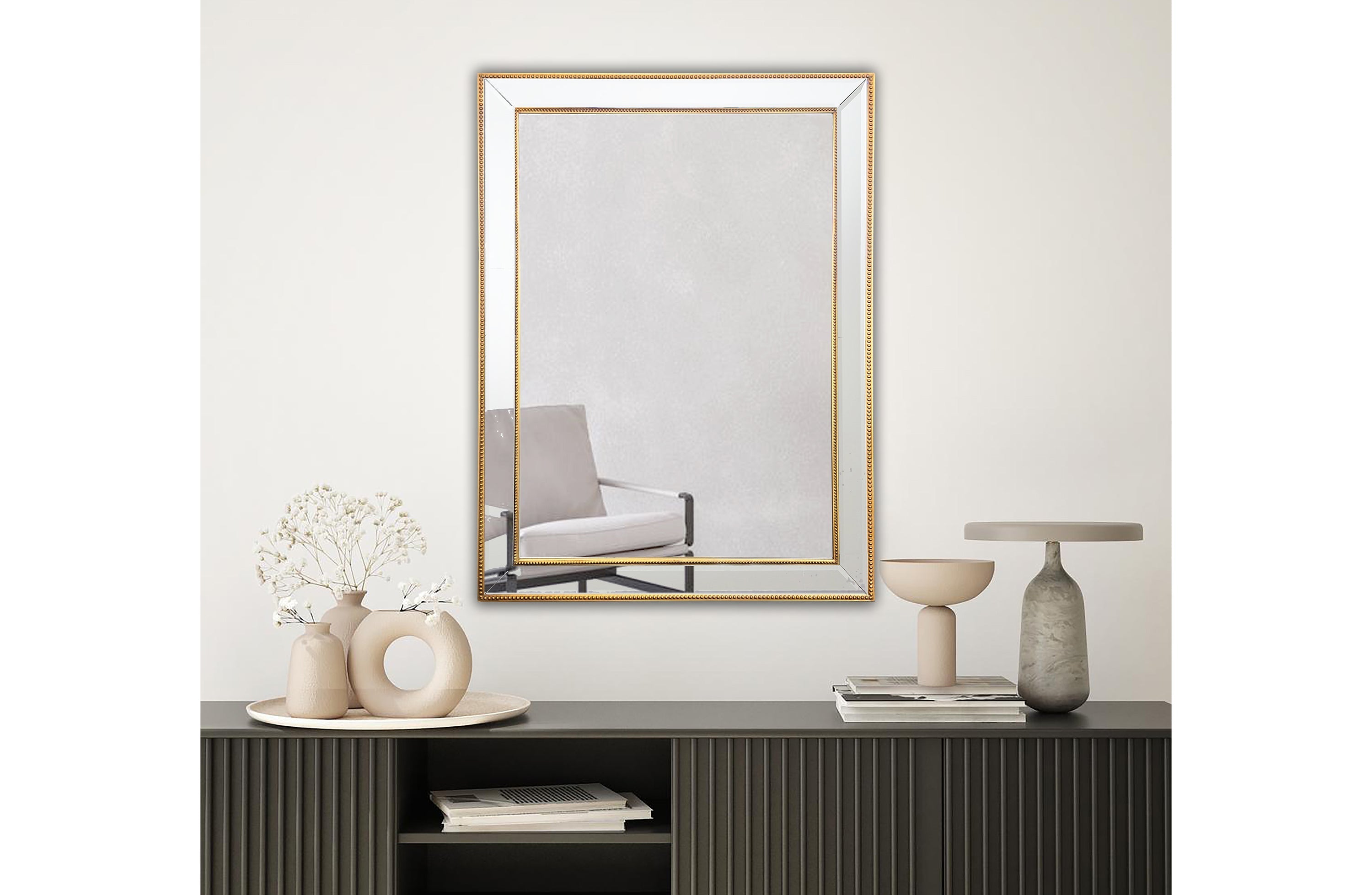Small gold beaded framed mirror displayed above buffet cabinet in dining area.
