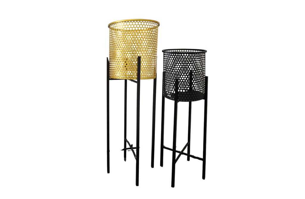 Set of two beehive-style planters, one in gold and one in black, both with black metal foldable stands. Displayed on a white background without plants.