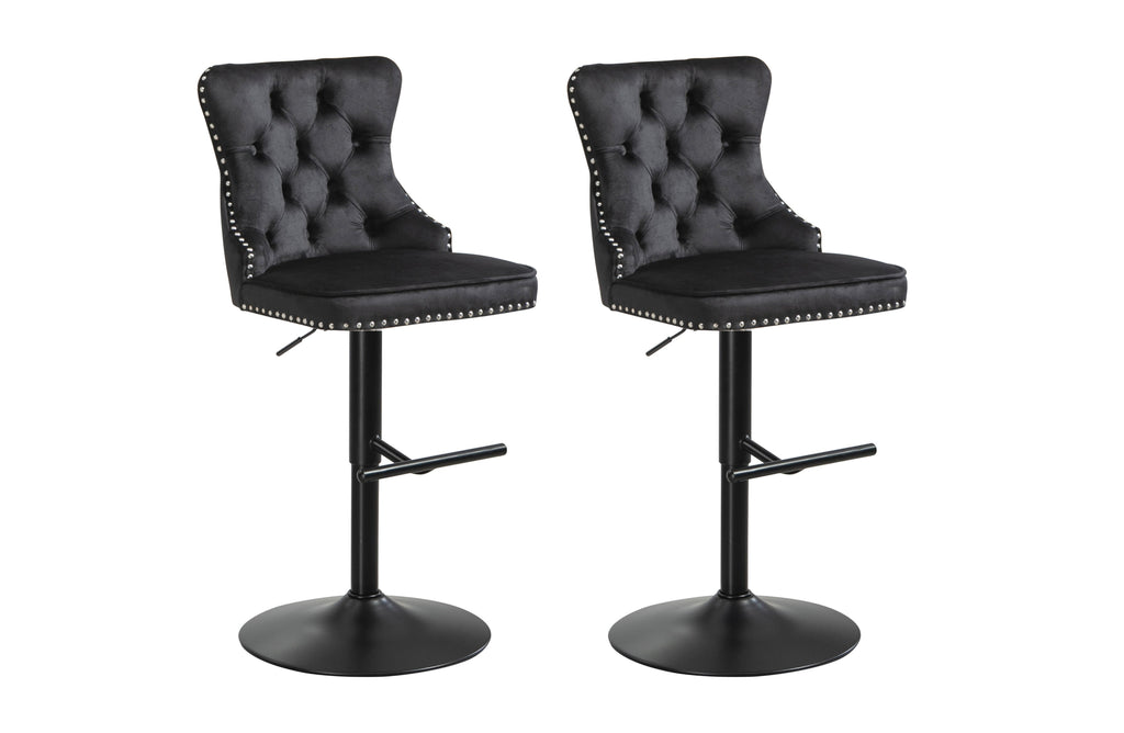 Pair of black velvet tufted swivel bar stools with stud trim and black metal base.