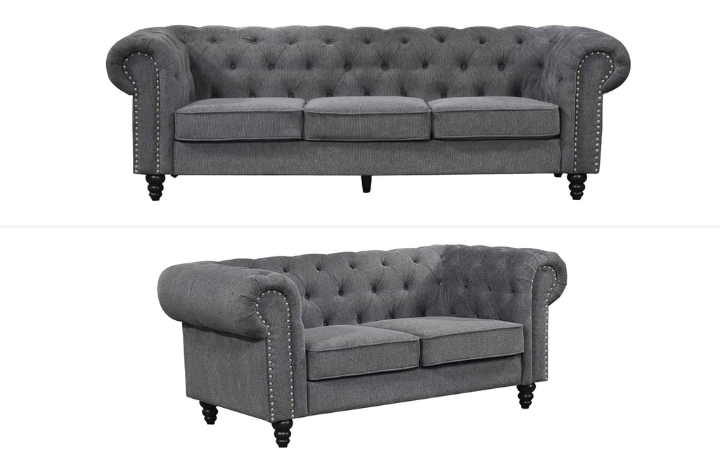 Charcoal grey Chesterfield tufted sofa set with classic three-seater and two-seater featuring rolled arms and timber legs