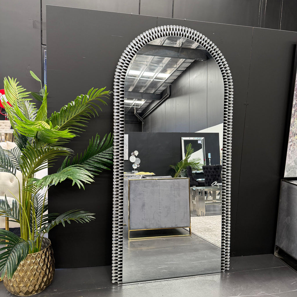 Diamond Arch extra large full length mirror styled in modern showroom with plants and décor.