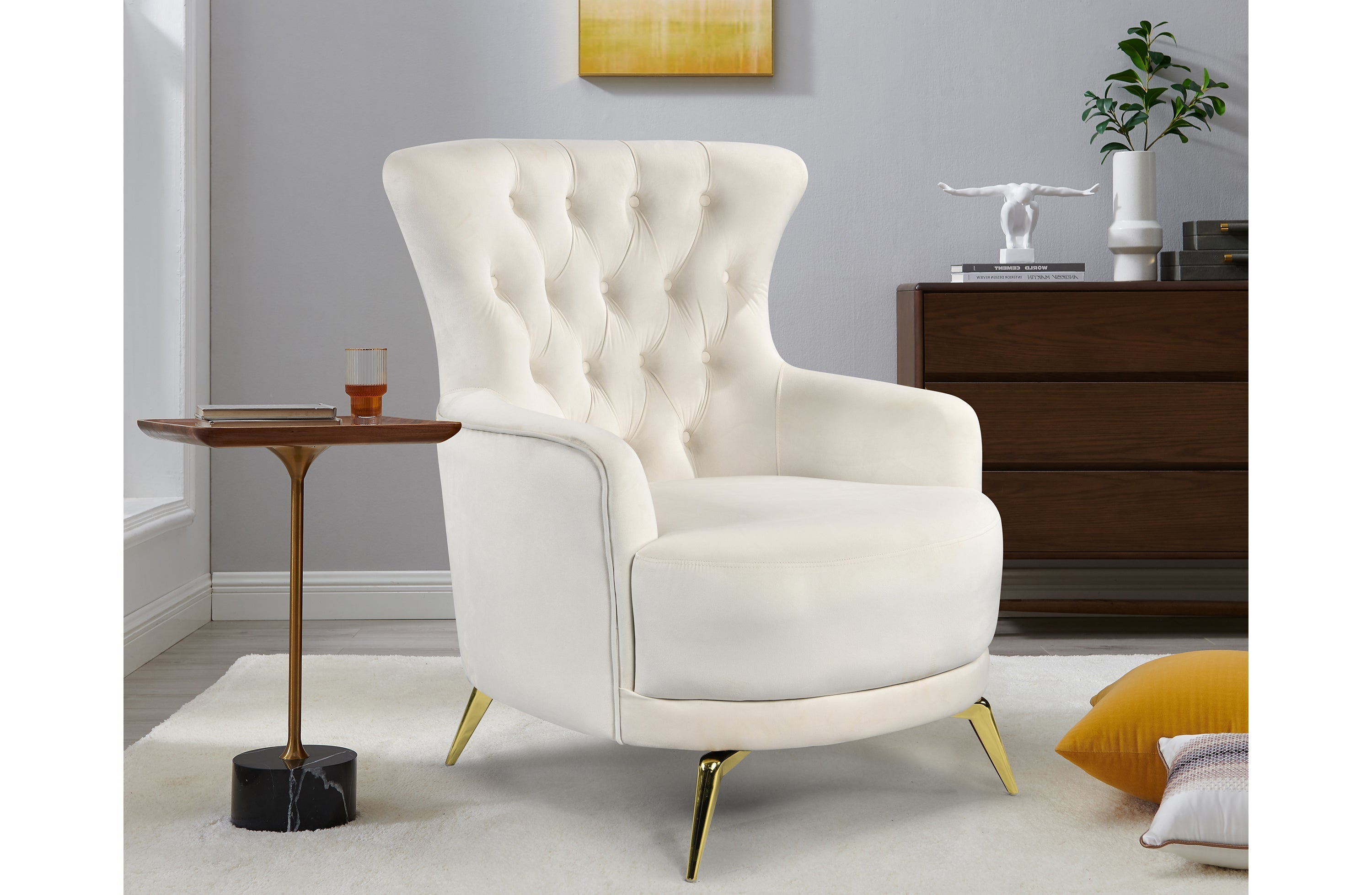 GRAND beige velvet tufted wing chair with gold legs styled in luxury living room