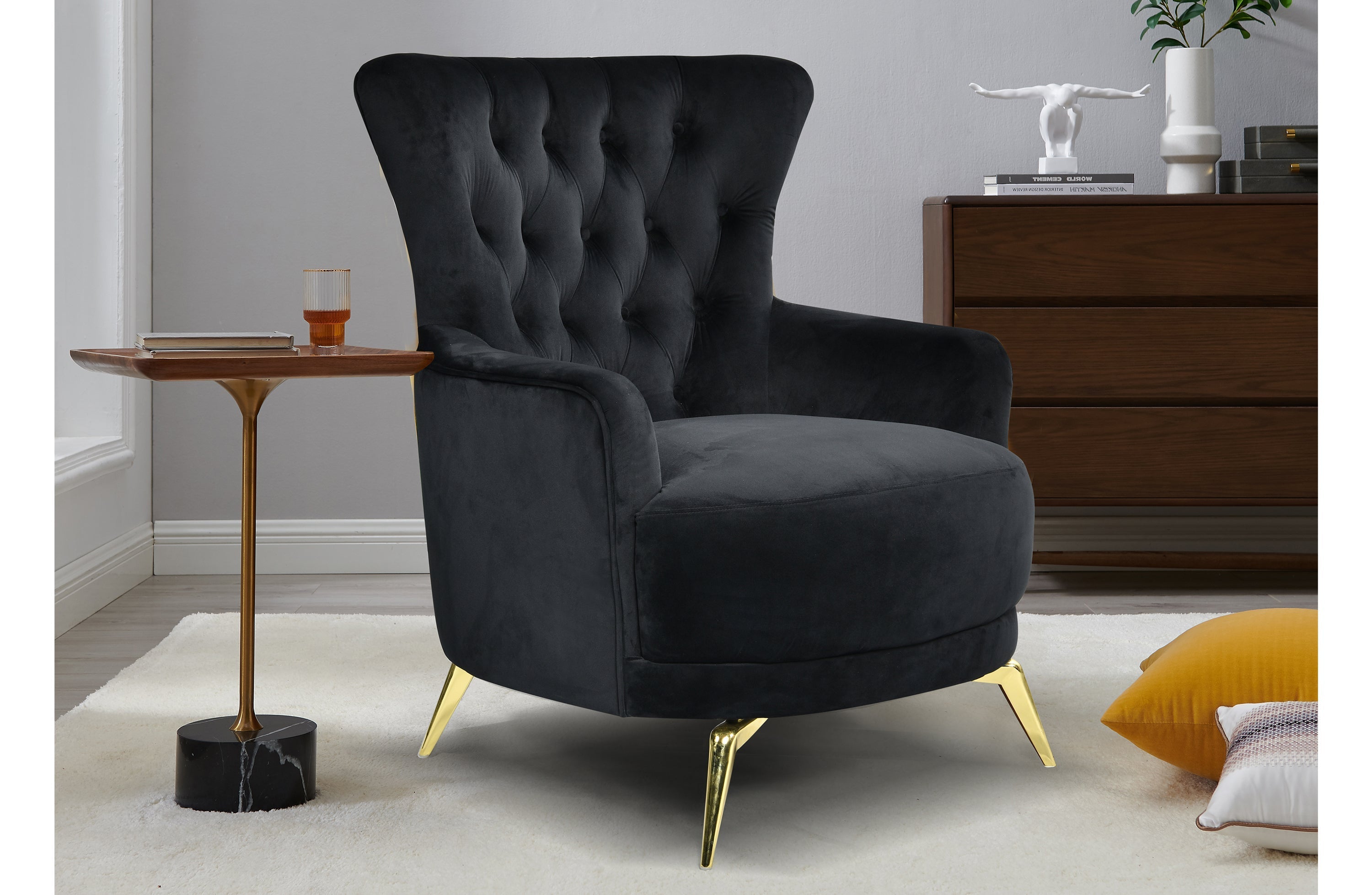 GRAND black velvet tufted wing chair styled in room with gold legs
