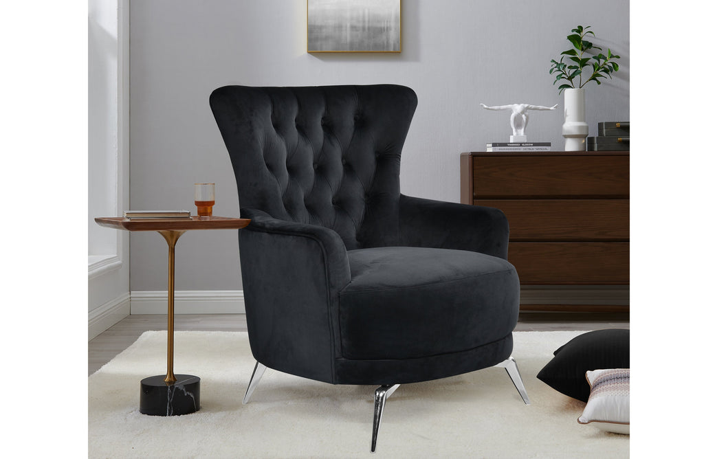 GRAND black velvet tufted wing chair styled in room with silver legs