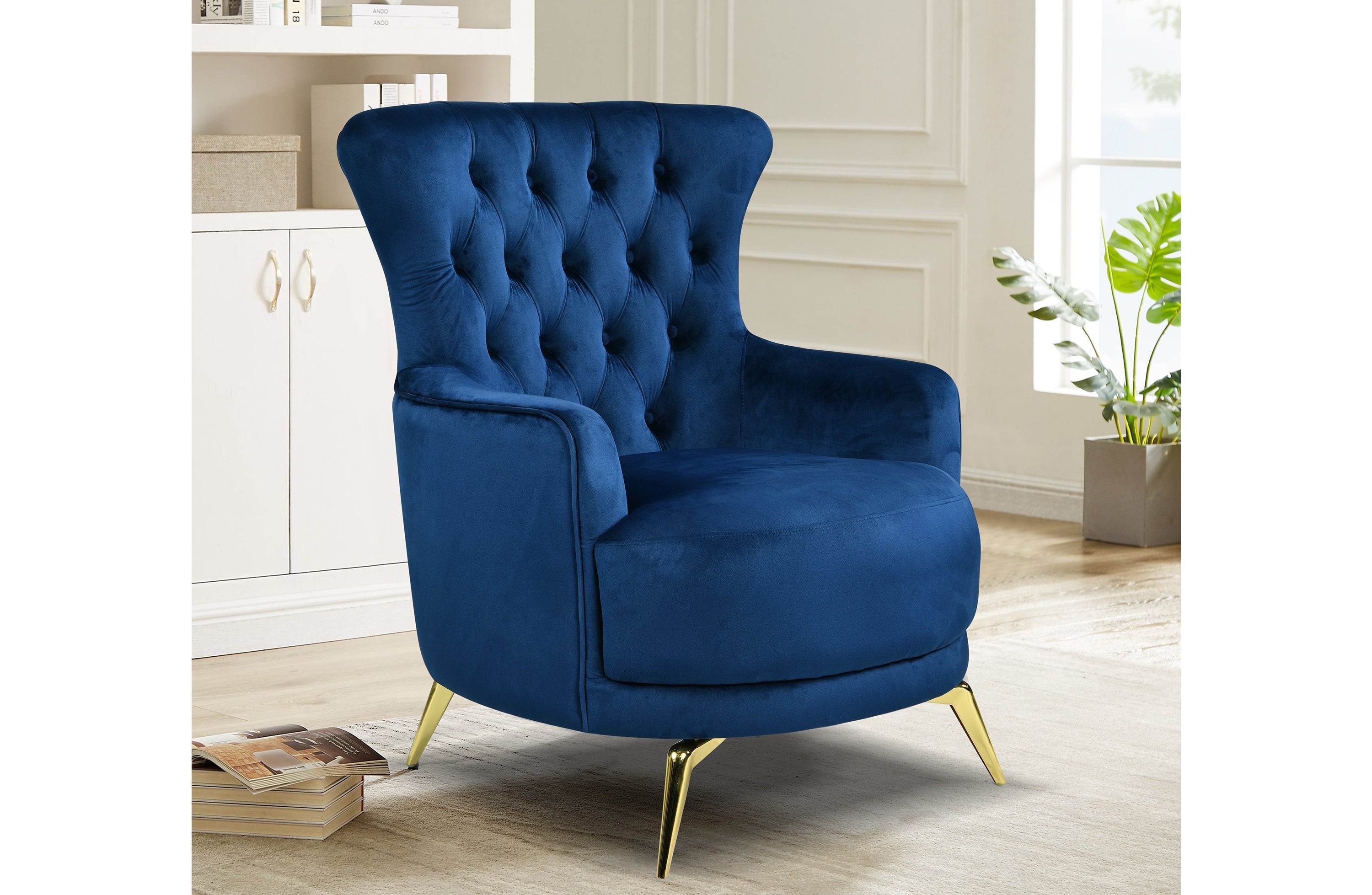 GRAND blue velvet tufted wing chair with gold legs styled in chic interior