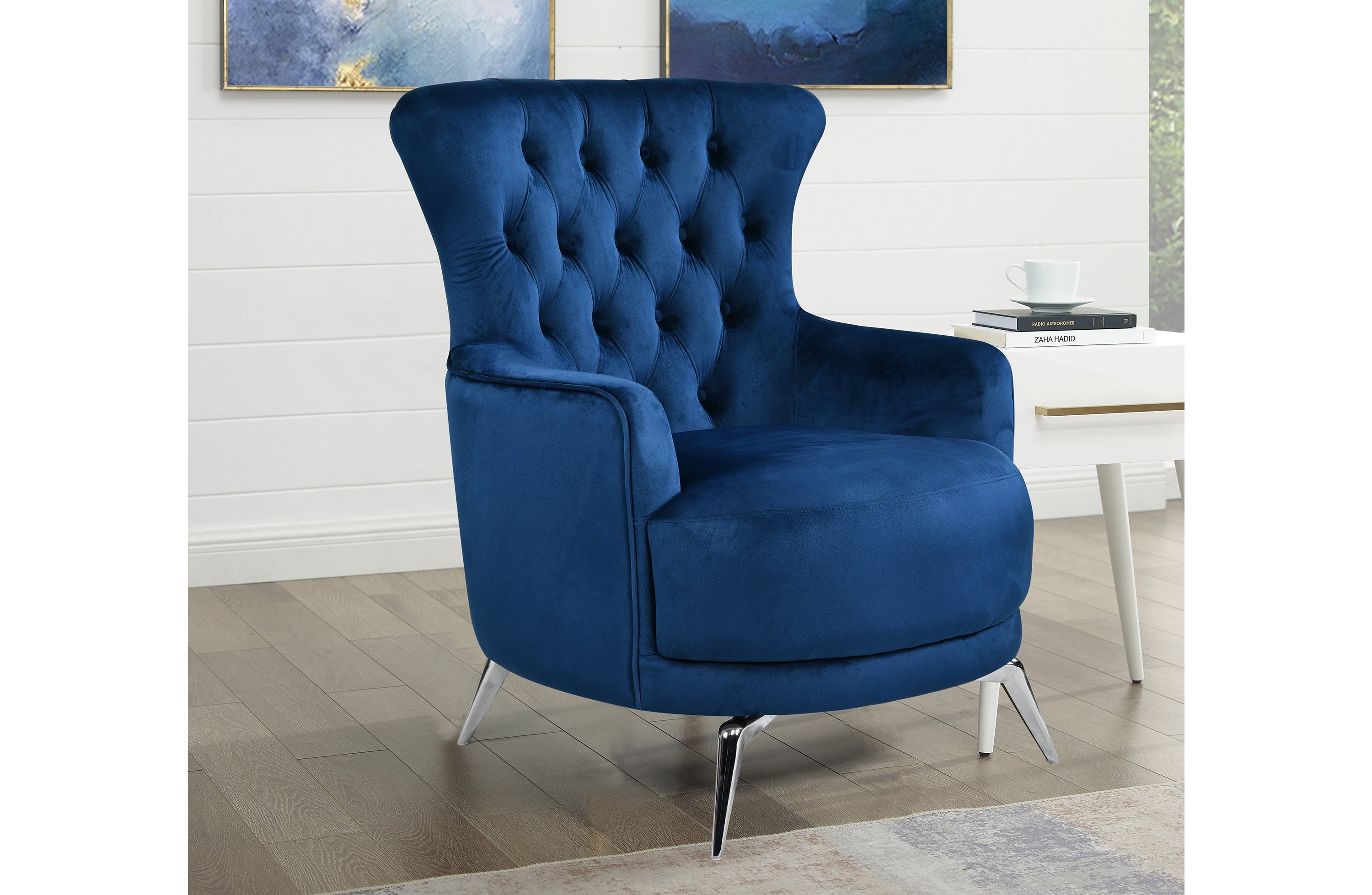 GRAND blue velvet tufted wing chair with silver legs styled in luxury living space