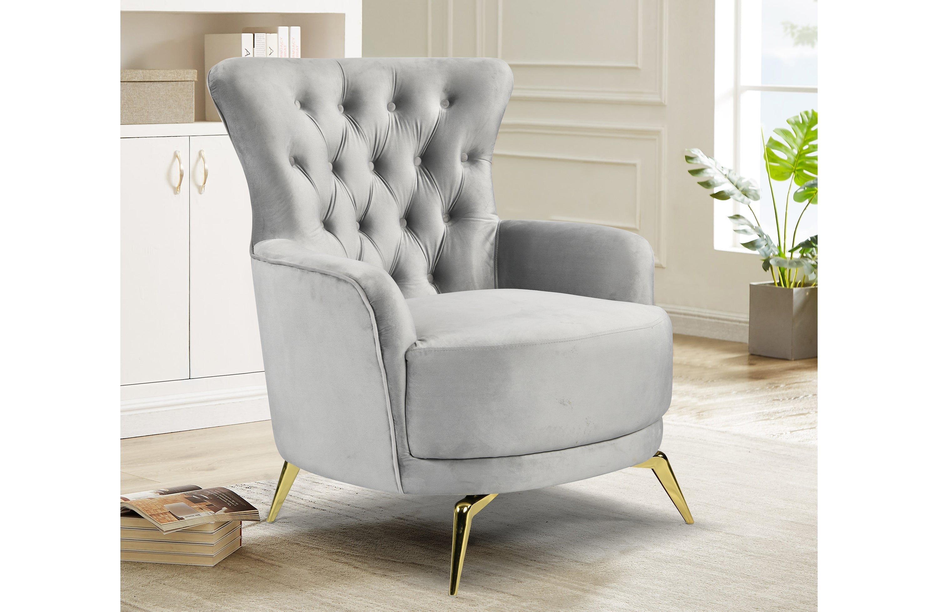 GRAND light grey velvet tufted wing chair with elegant gold legs styled in a luxury living room