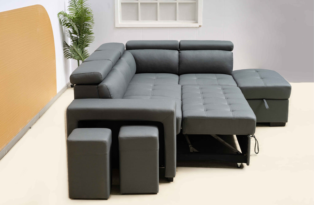 Dark grey Hamilton modular chaise lounge styled in room, extended bed and ottoman storage open.