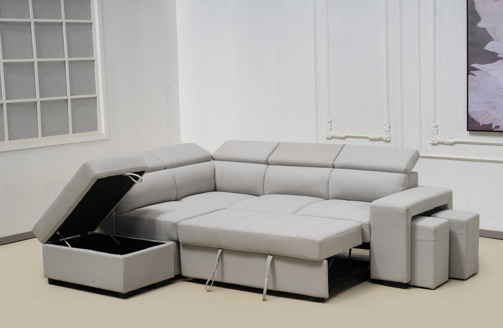 Light grey Hamilton modular chaise lounge converted into bed with storage ottoman open.