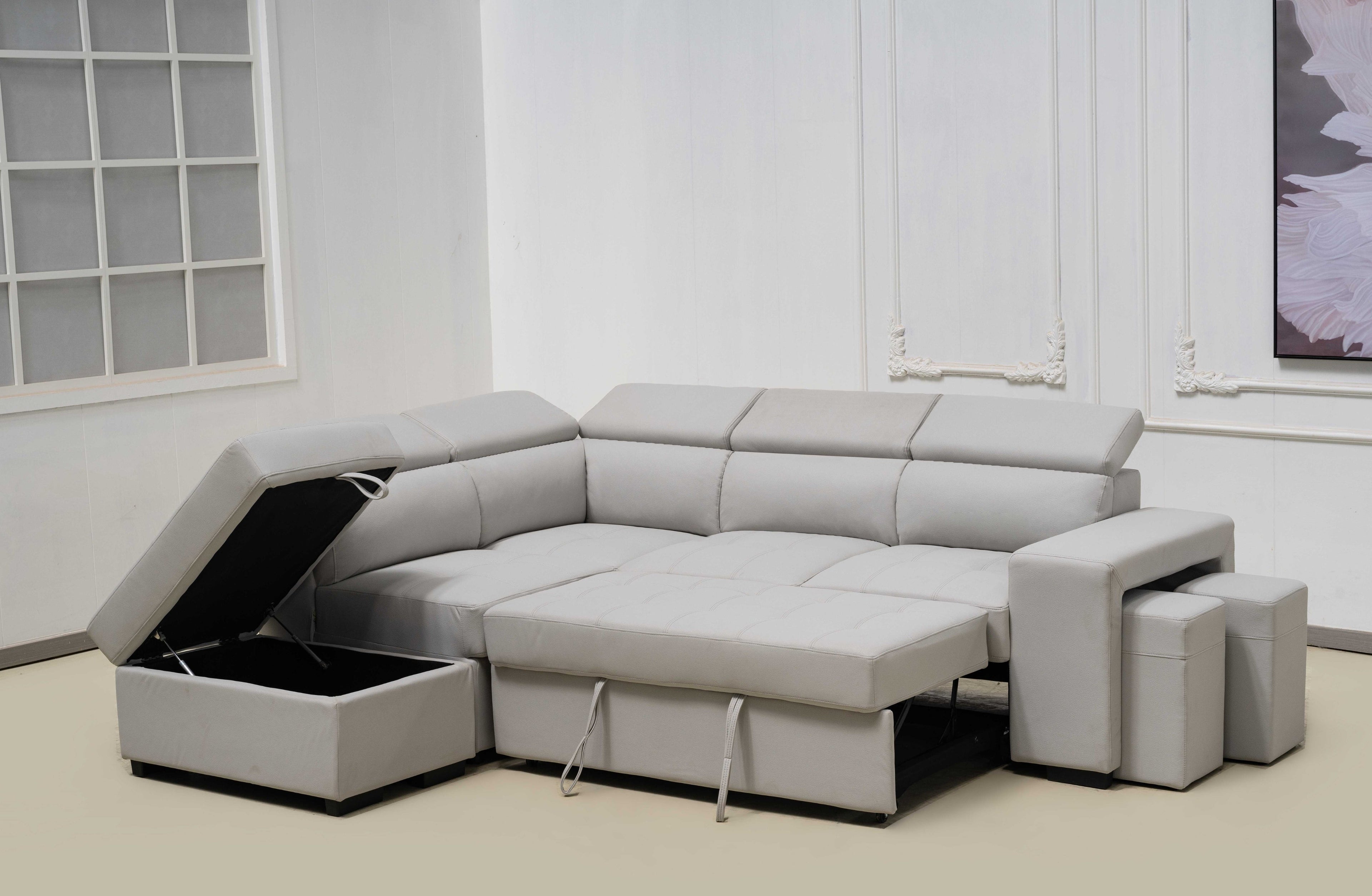 Light grey Hamilton modular chaise lounge converted into bed with storage ottoman open.