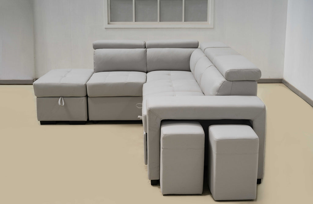 Light grey Hamilton modular chaise lounge with storage ottoman and stools in modern interior.
