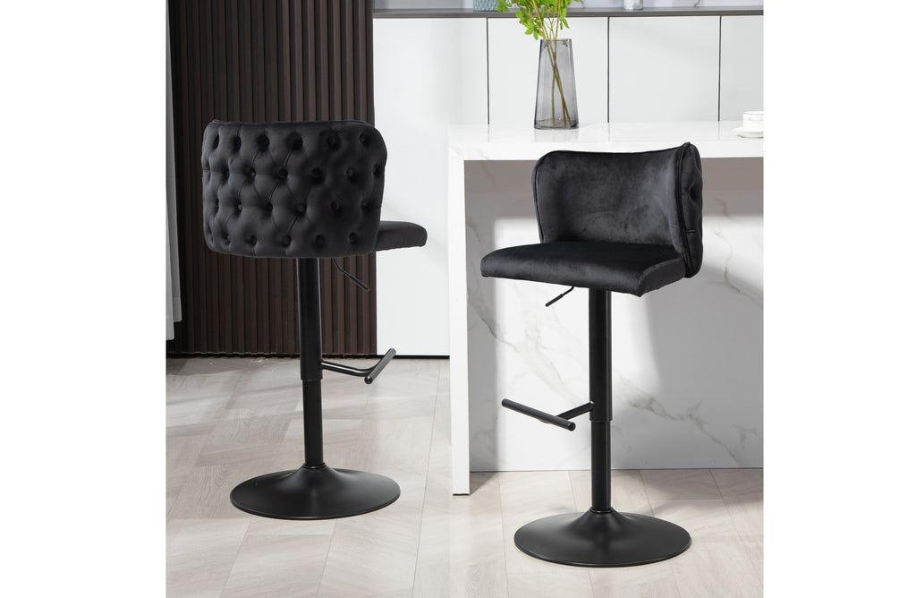 Pair of Lara black velvet swivel bar stools with matte black base in kitchen setting