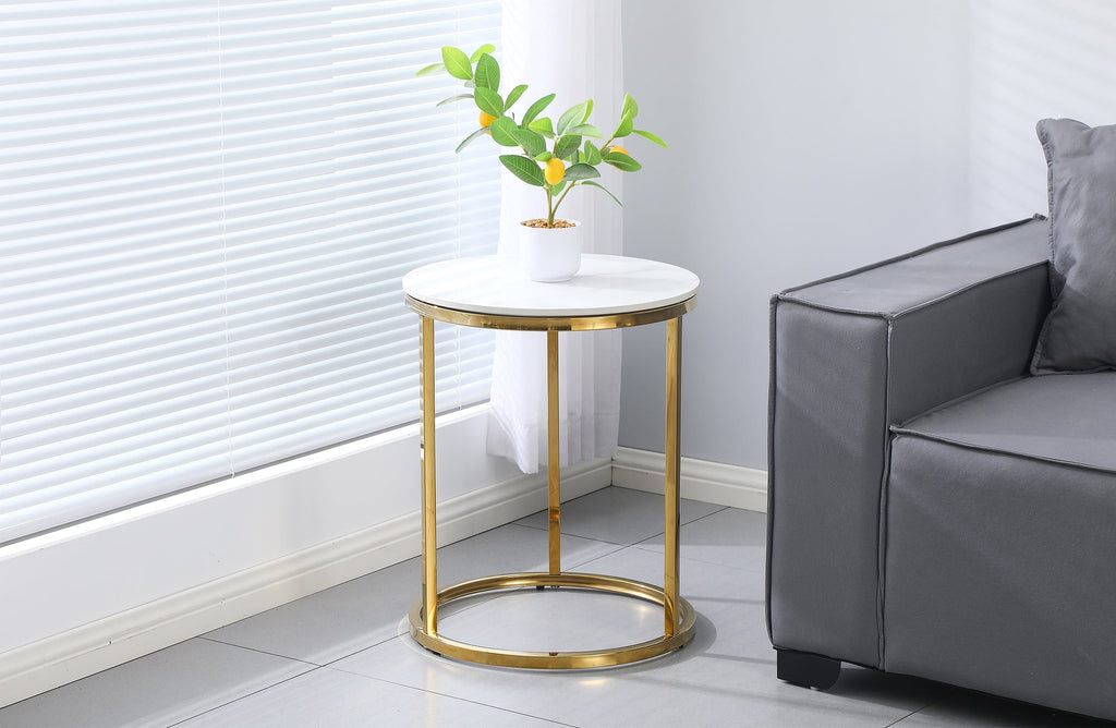 Layla side table styled in a modern living room, gold frame with marble top complementing grey sofa décor.