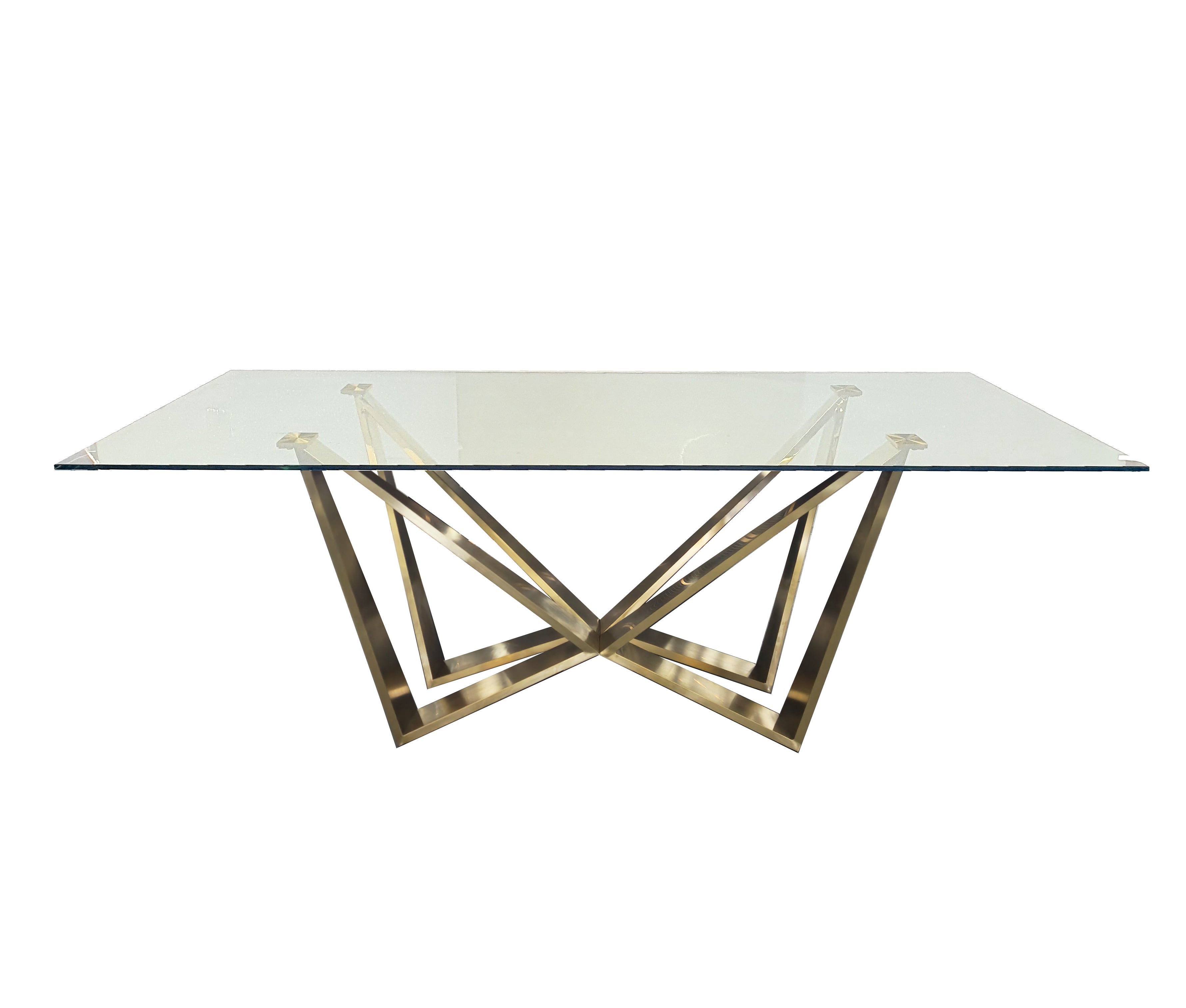 Lenox Dining Table with polished gold stainless steel frame and clear tempered glass top.
