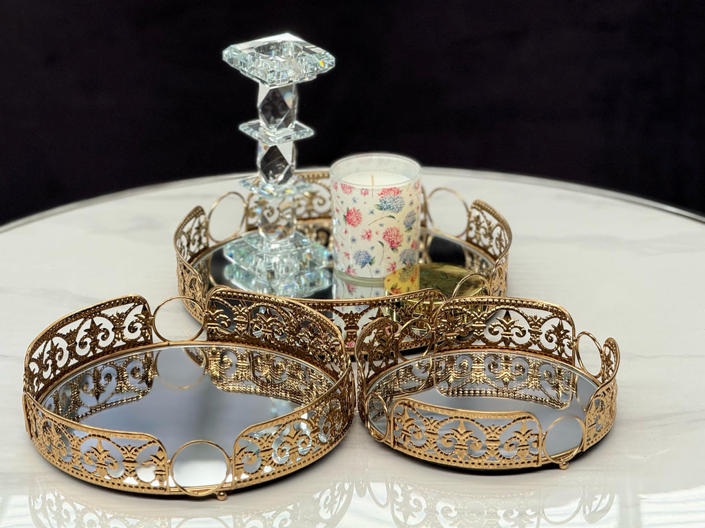 Decorative gold round Lucy tray set of 3 styled with candles and crystal décor – perfect for elegant tabletop accents.