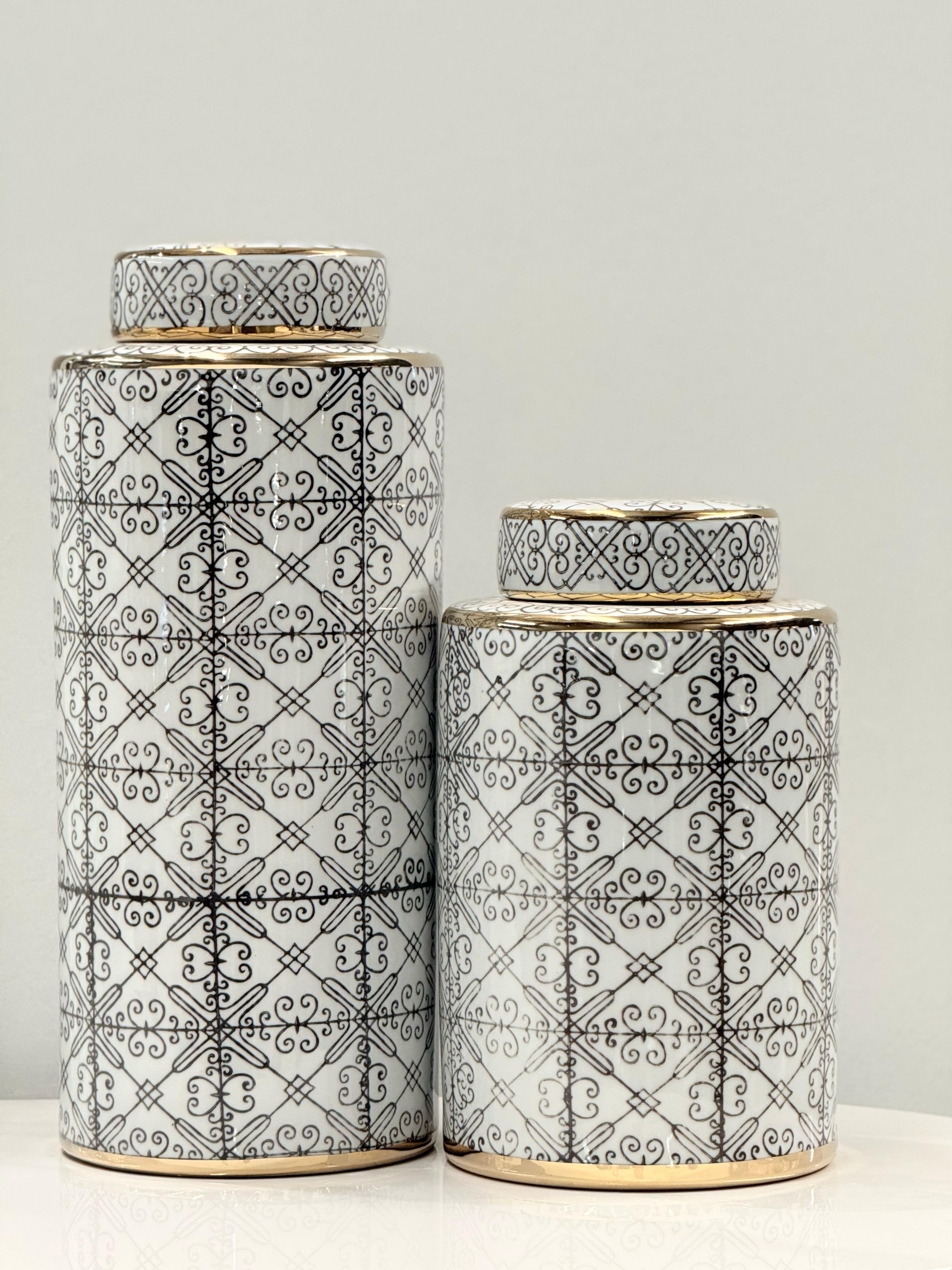 Chic ceramic canister set with intricate black patterns and gold accents, ideal for décor.