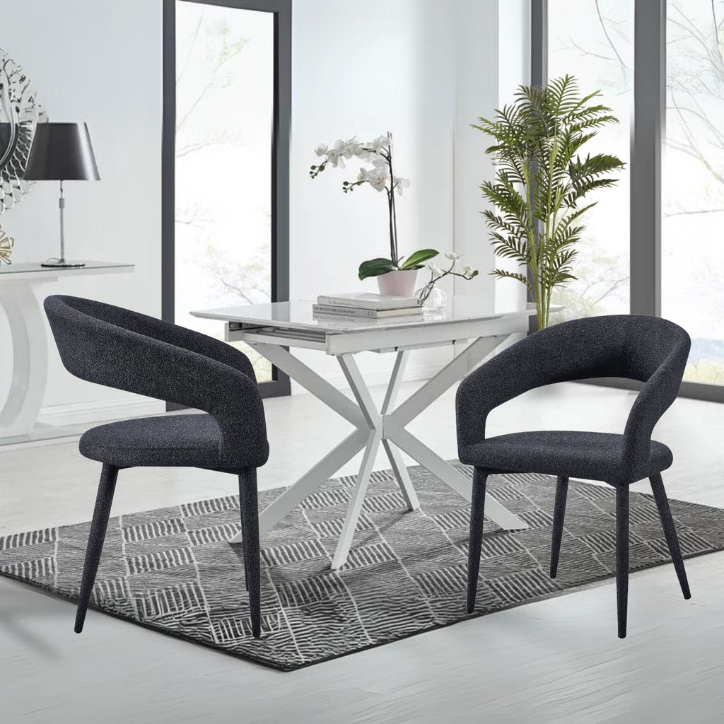 Marilyn boucle dining chairs in charcoal fabric styled with white dining table in a modern bright room.