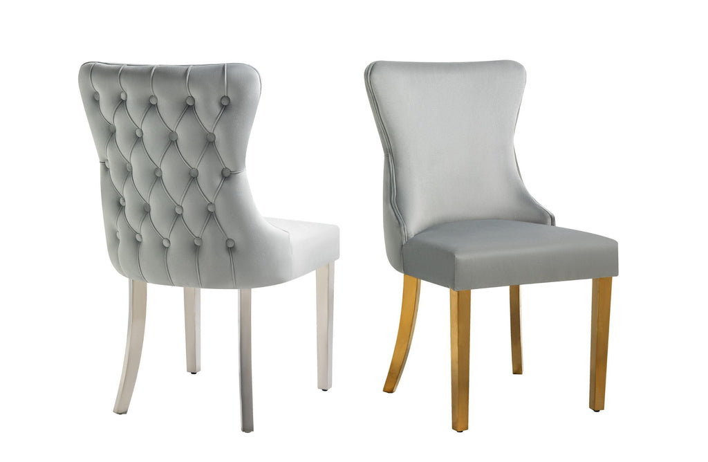 Light grey velvet Paris chairs, one gold-legged and one silver-legged, tufted back detailing.