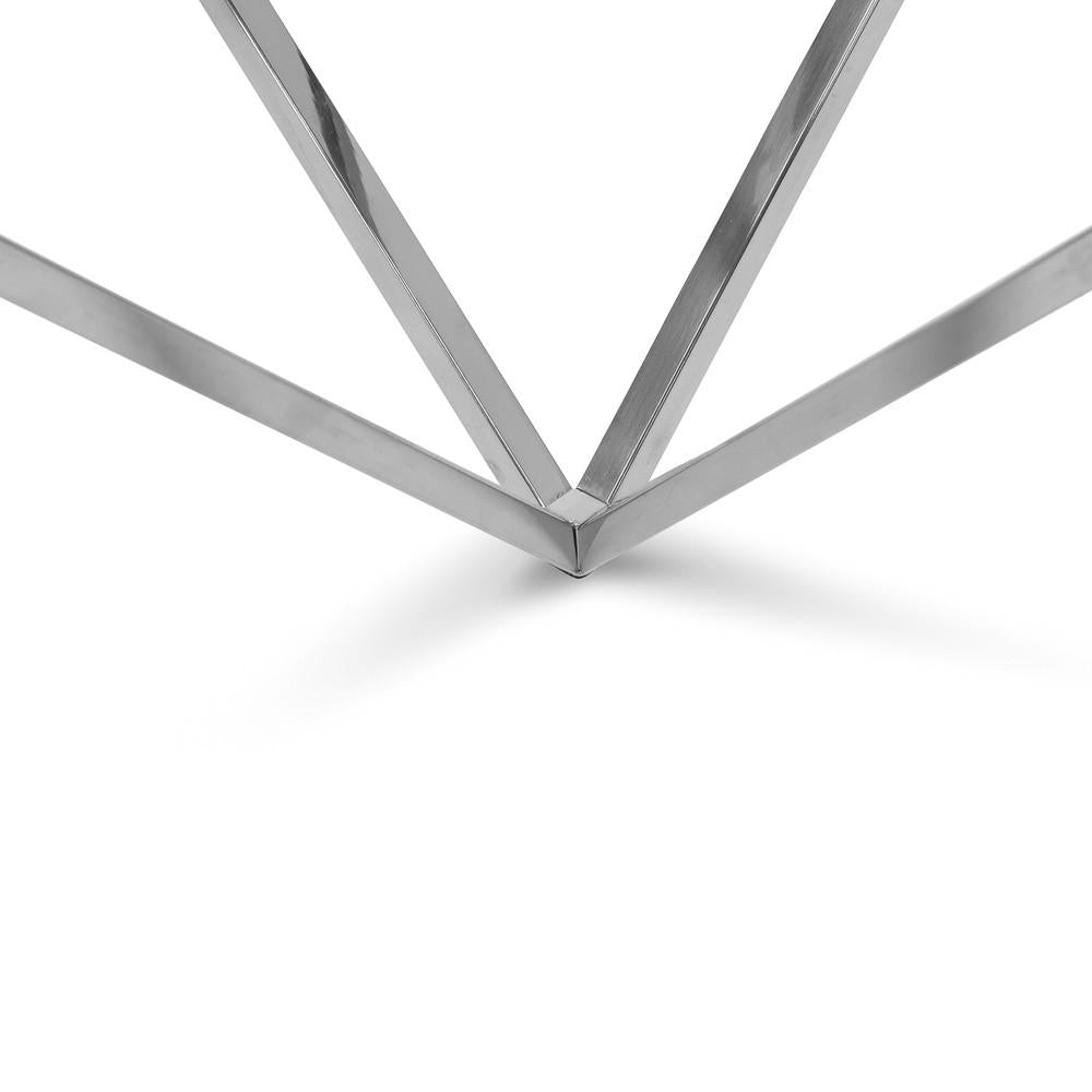 Close-up of silver pyramid table polished steel frame with geometric triangular base