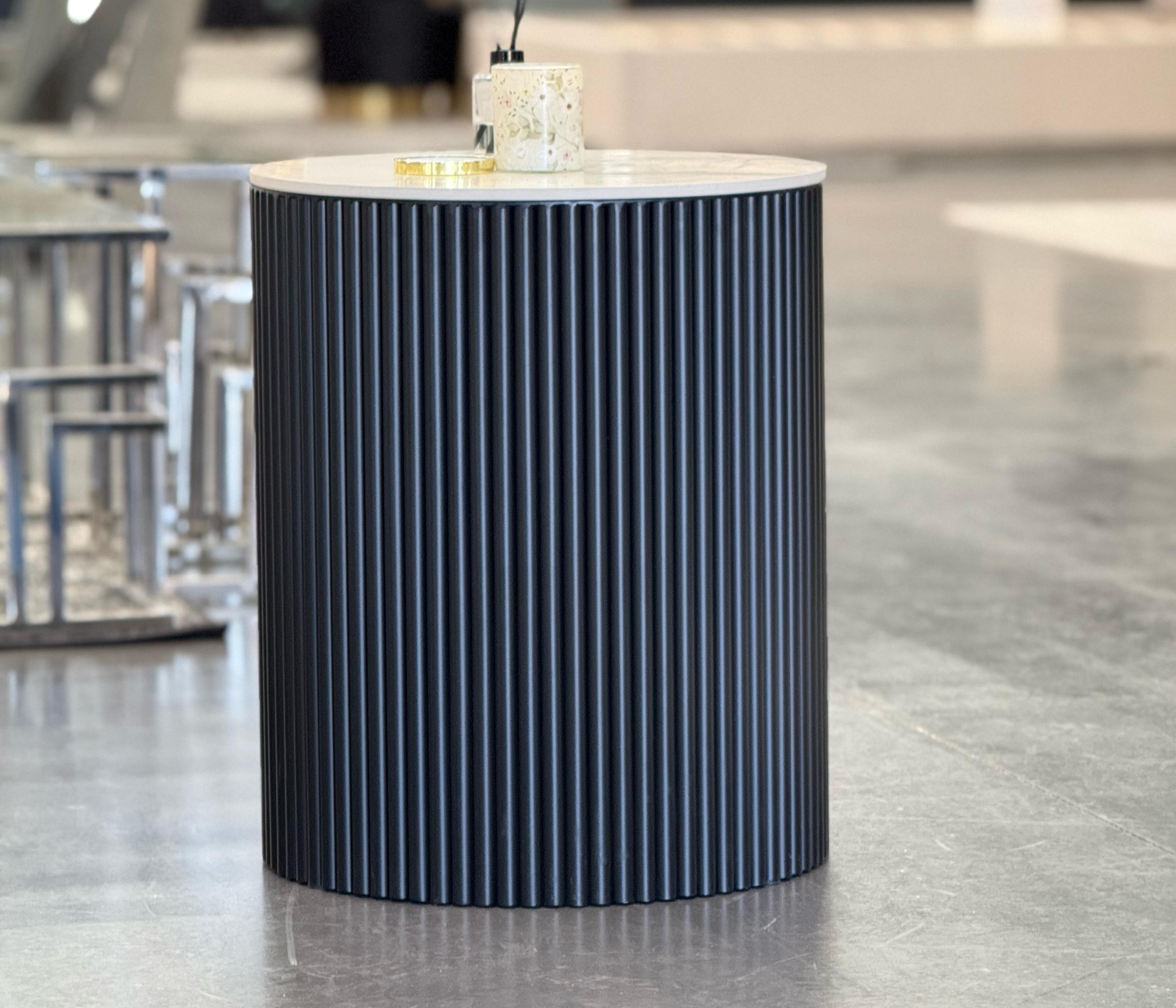 Ripple black round side table with marble top in showroom display