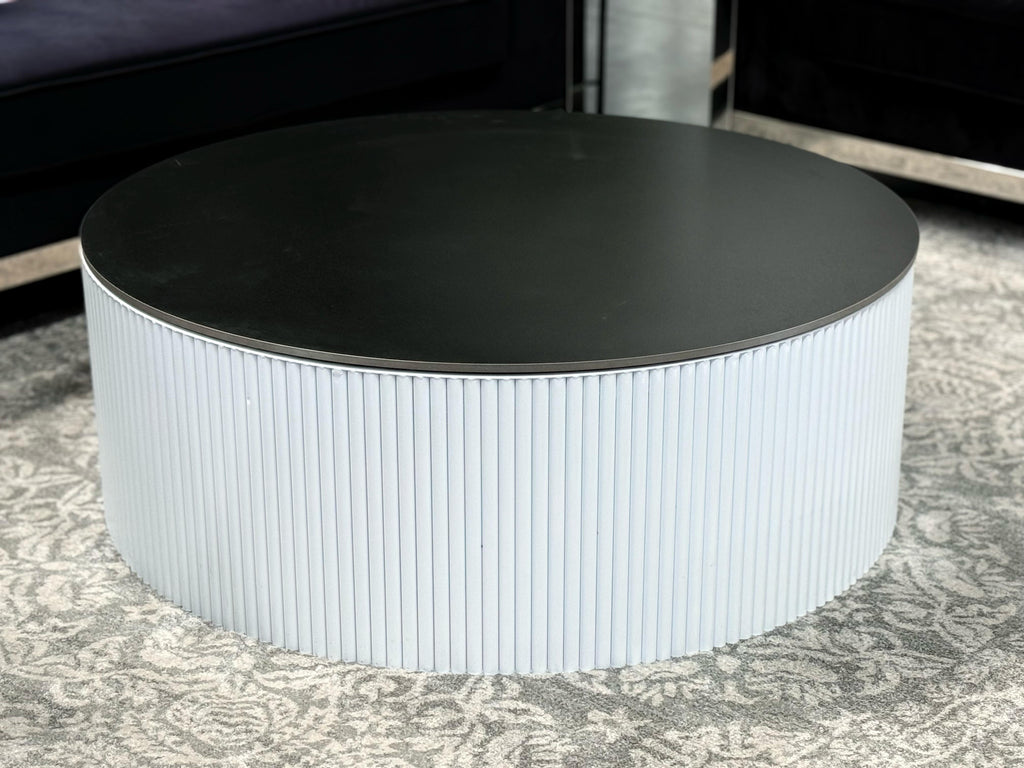 White Ripple coffee table with black top styled in living room décor
