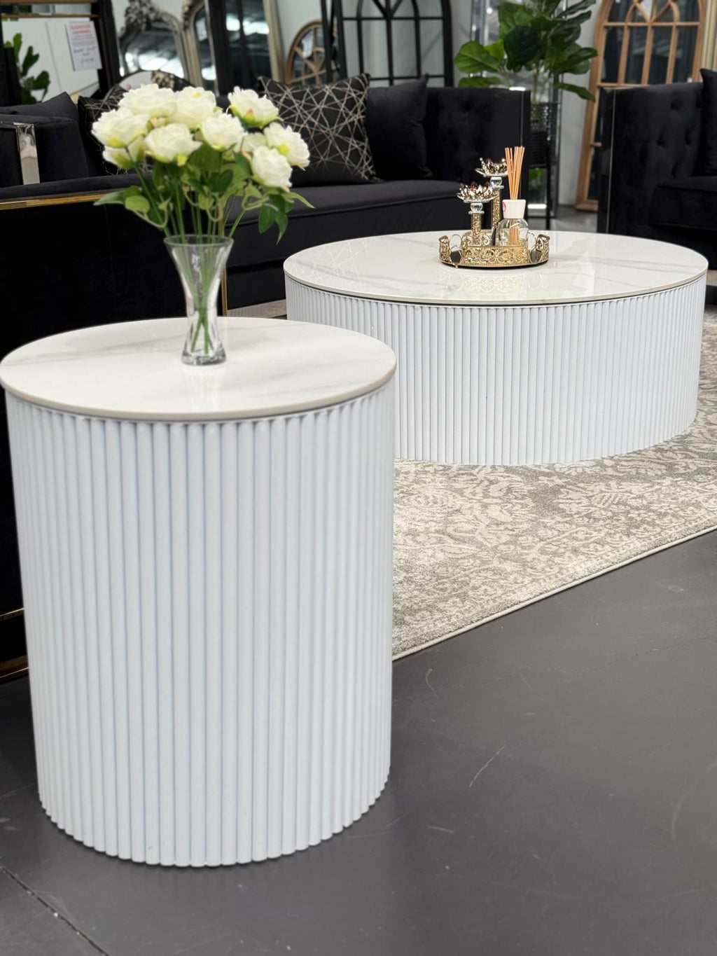 Ripple coffee and side table with white ribbed base styled in modern living room