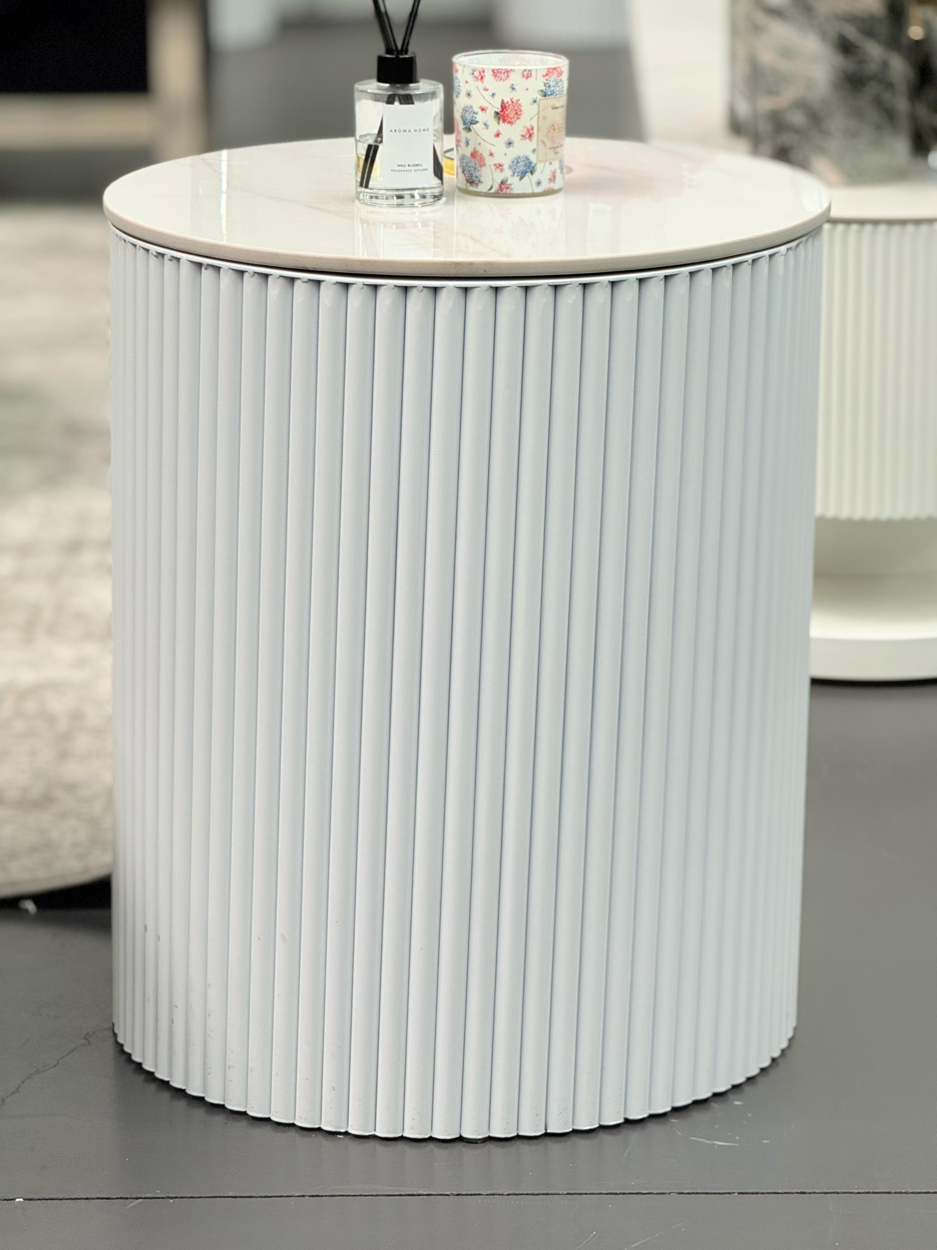 White Ripple round side table with ribbed body styled in living room