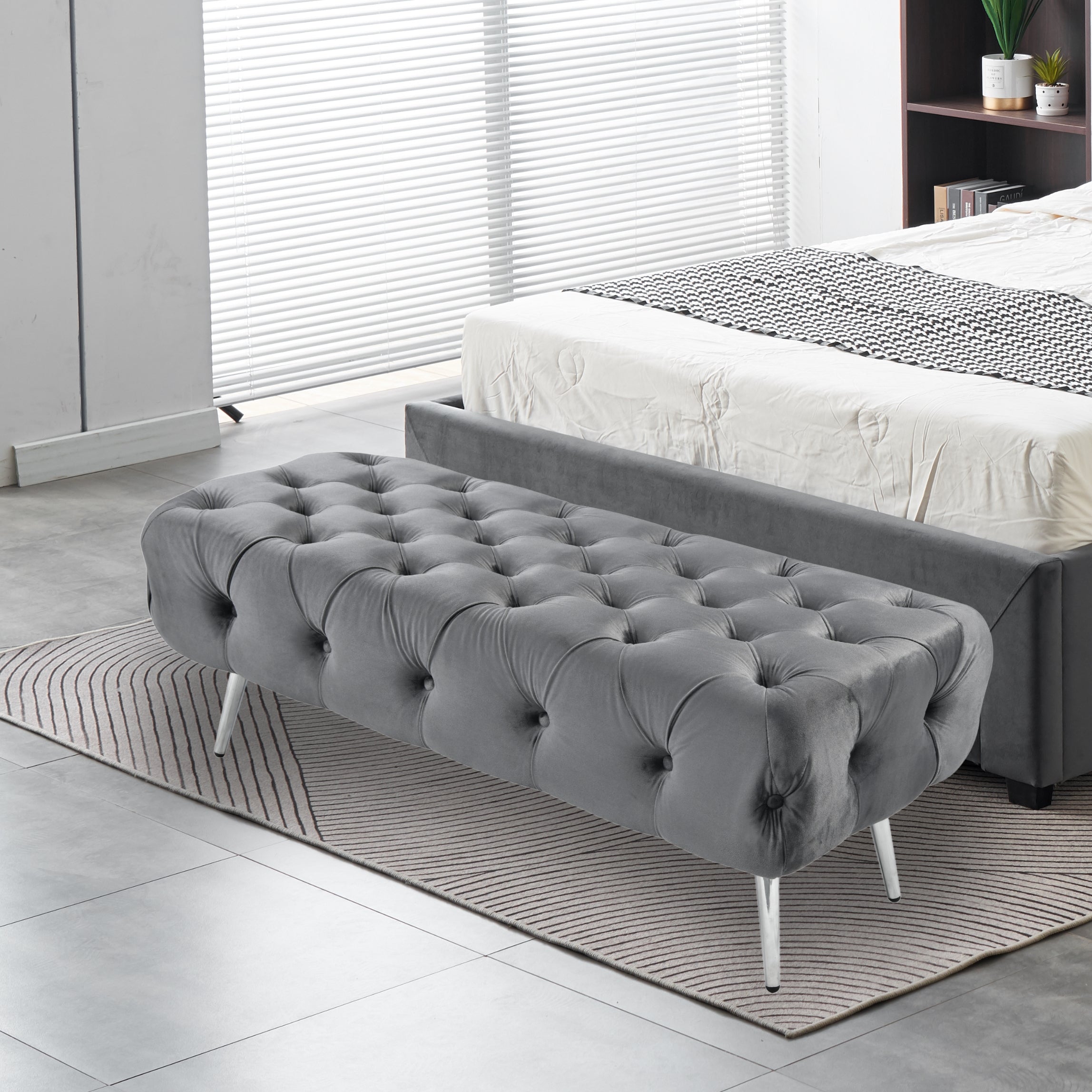 Light Grey Shirley Ottoman with silver frame styled at bed end, tufted velvet seating