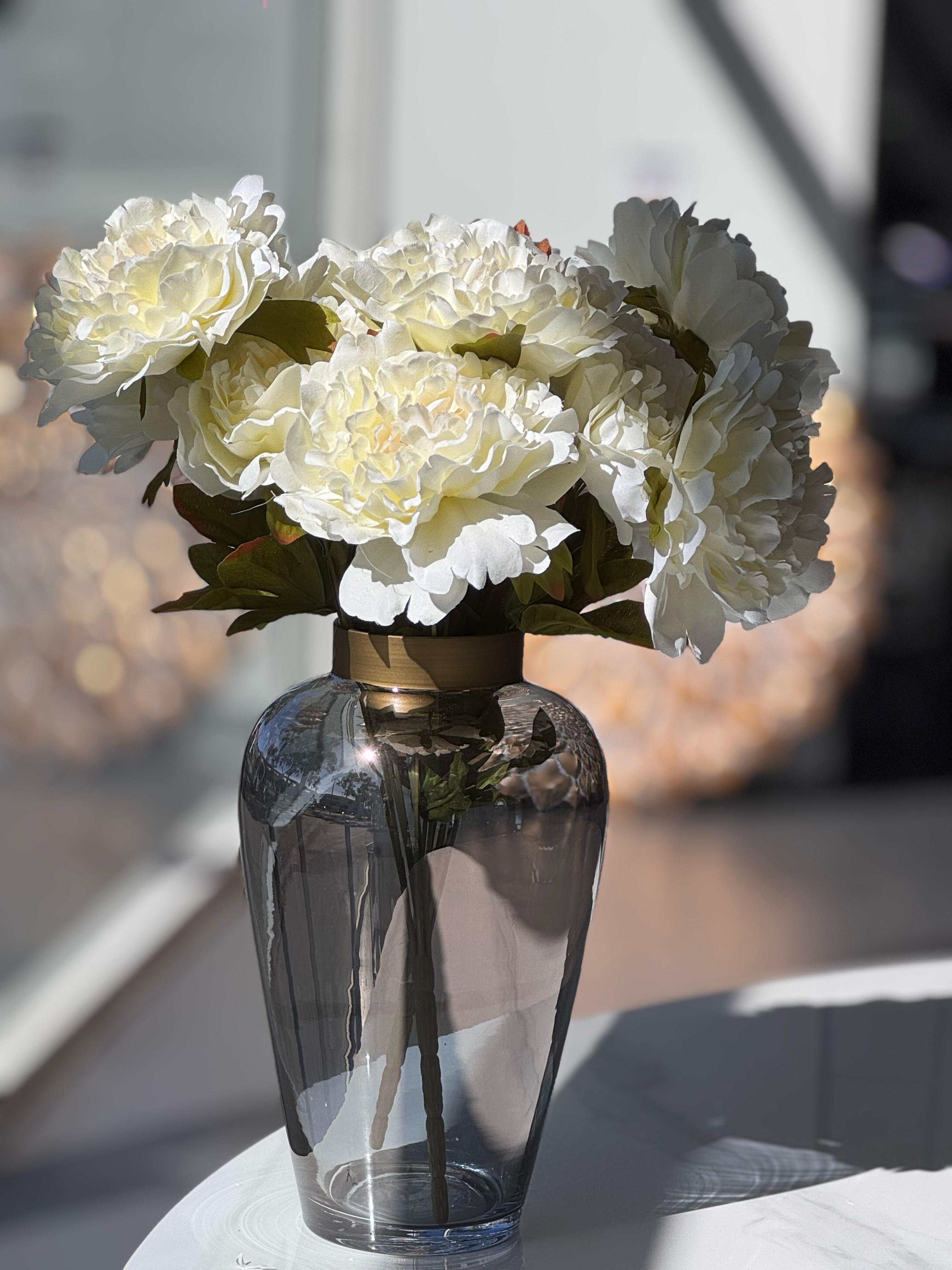 Smoked glass vase with gold rim, styled with lush white florals for a soft and elegant touch.