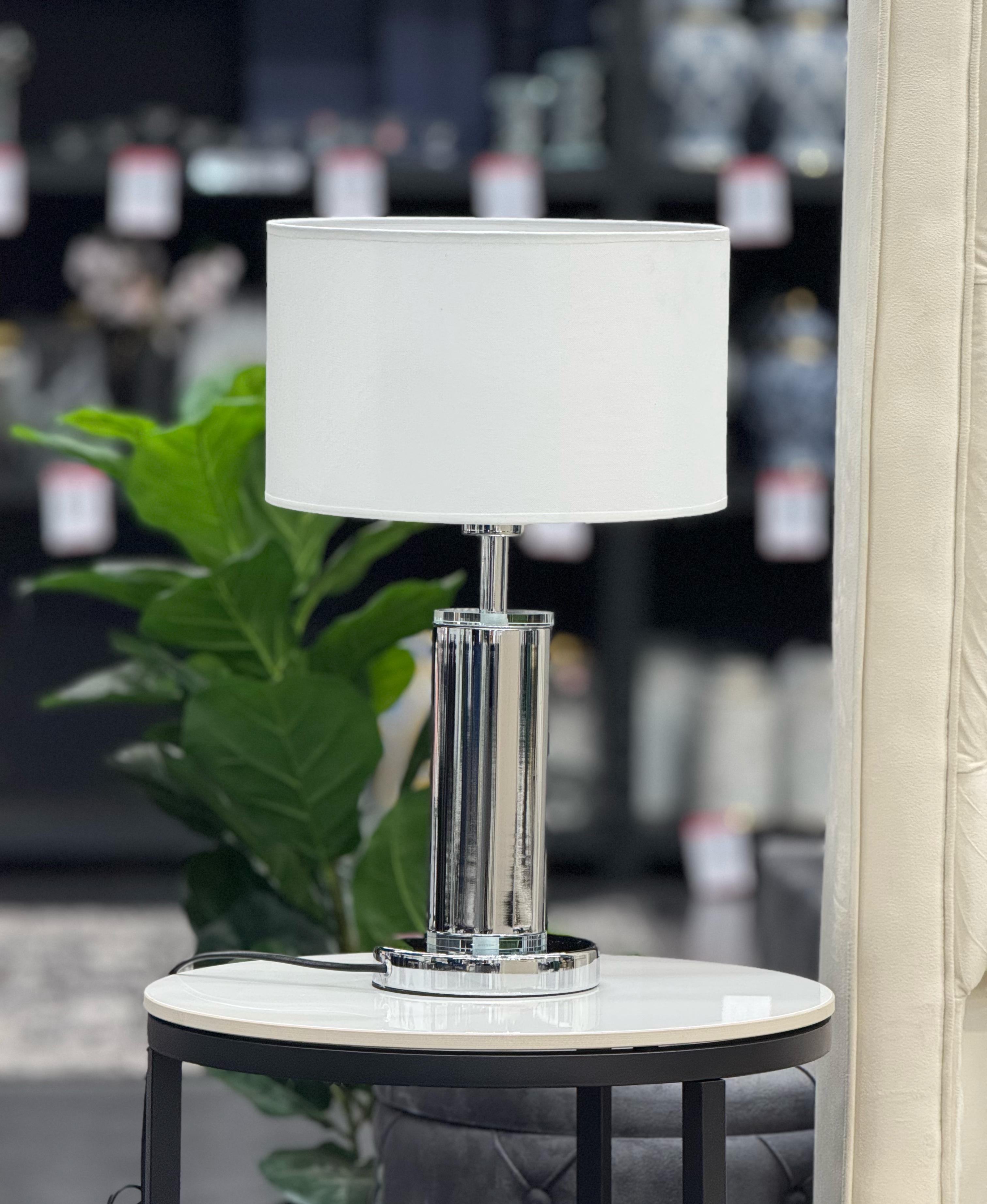 Tiffany Table Lamp with silver base and white lampshade styled on side table in living room