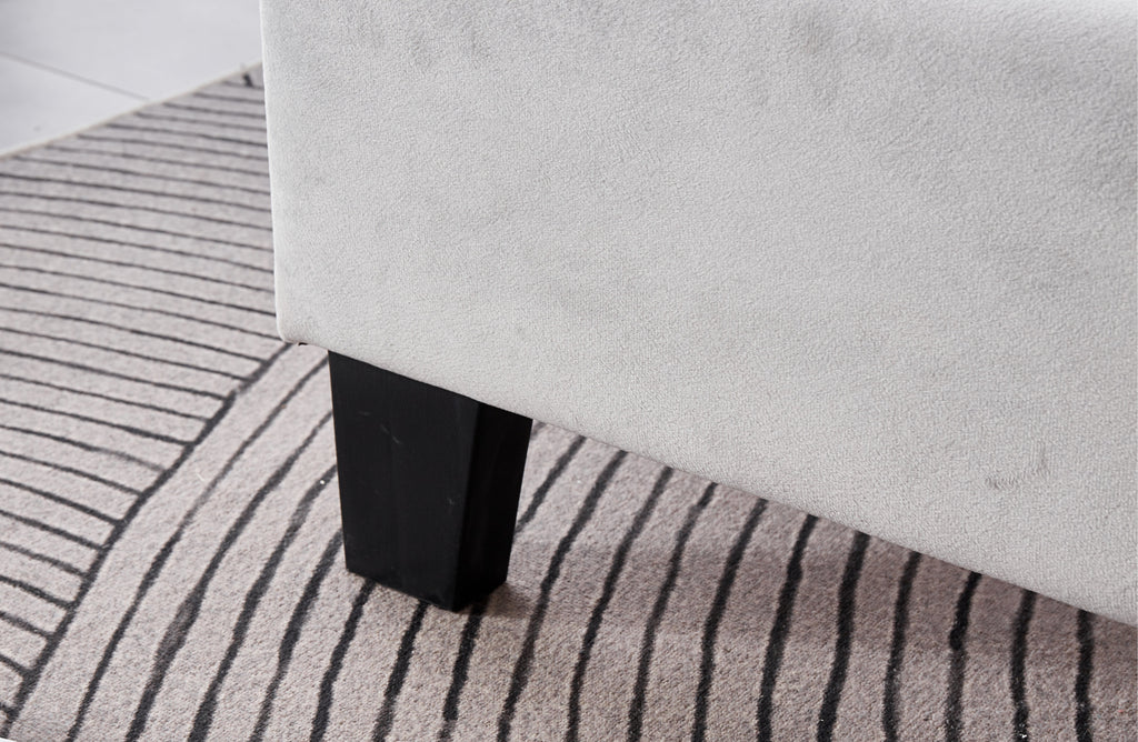 Close-up of Winston Velvet Bed sturdy black legs with premium light grey velvet base